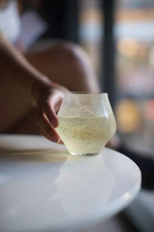 A person is holding a glass of wine