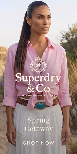 Woman wearing a pink shirt and white skirt standing outdoors with Superdry & Co Spring Getaway text.