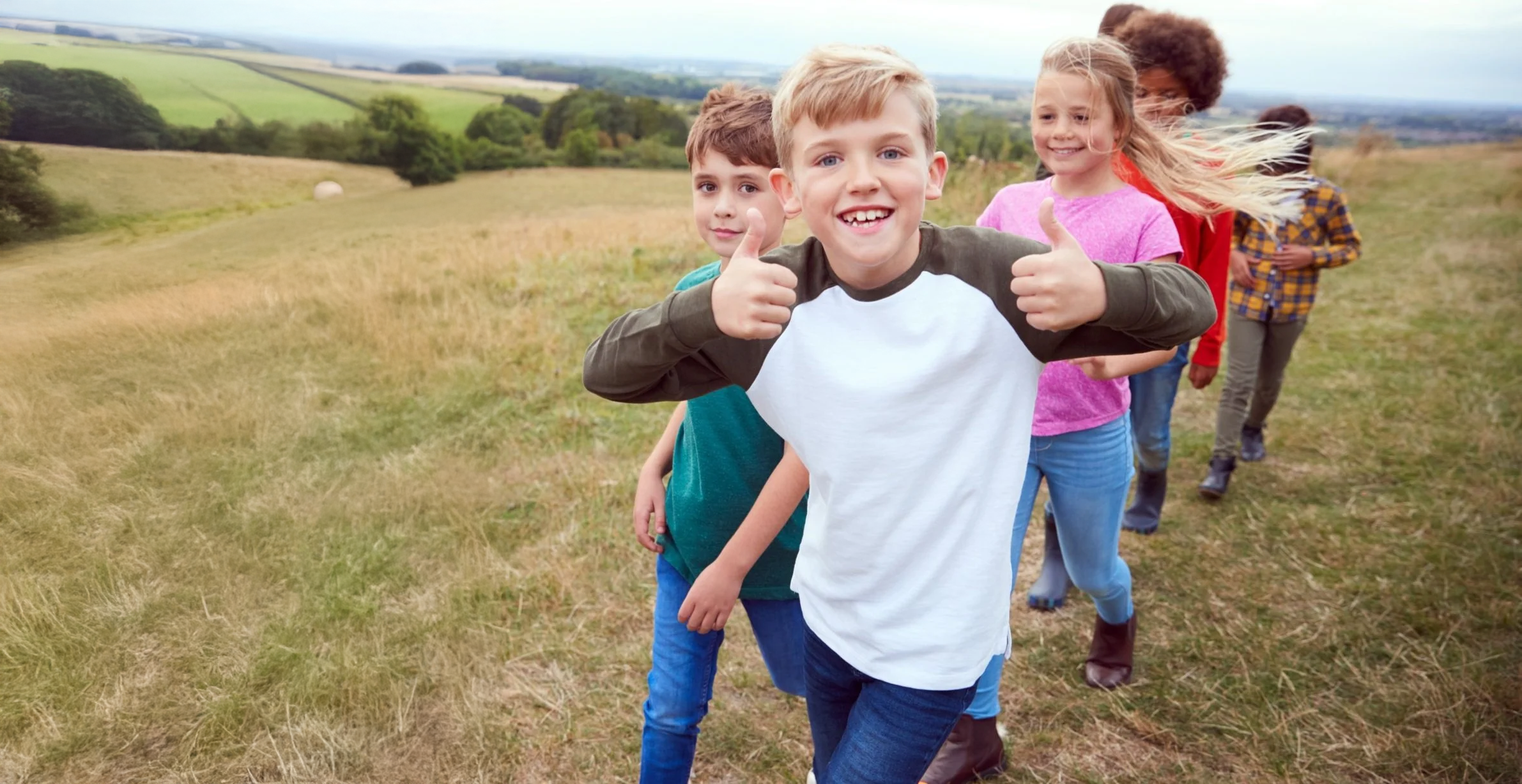 Children walking outdoors together at a social skills camp in Colorado