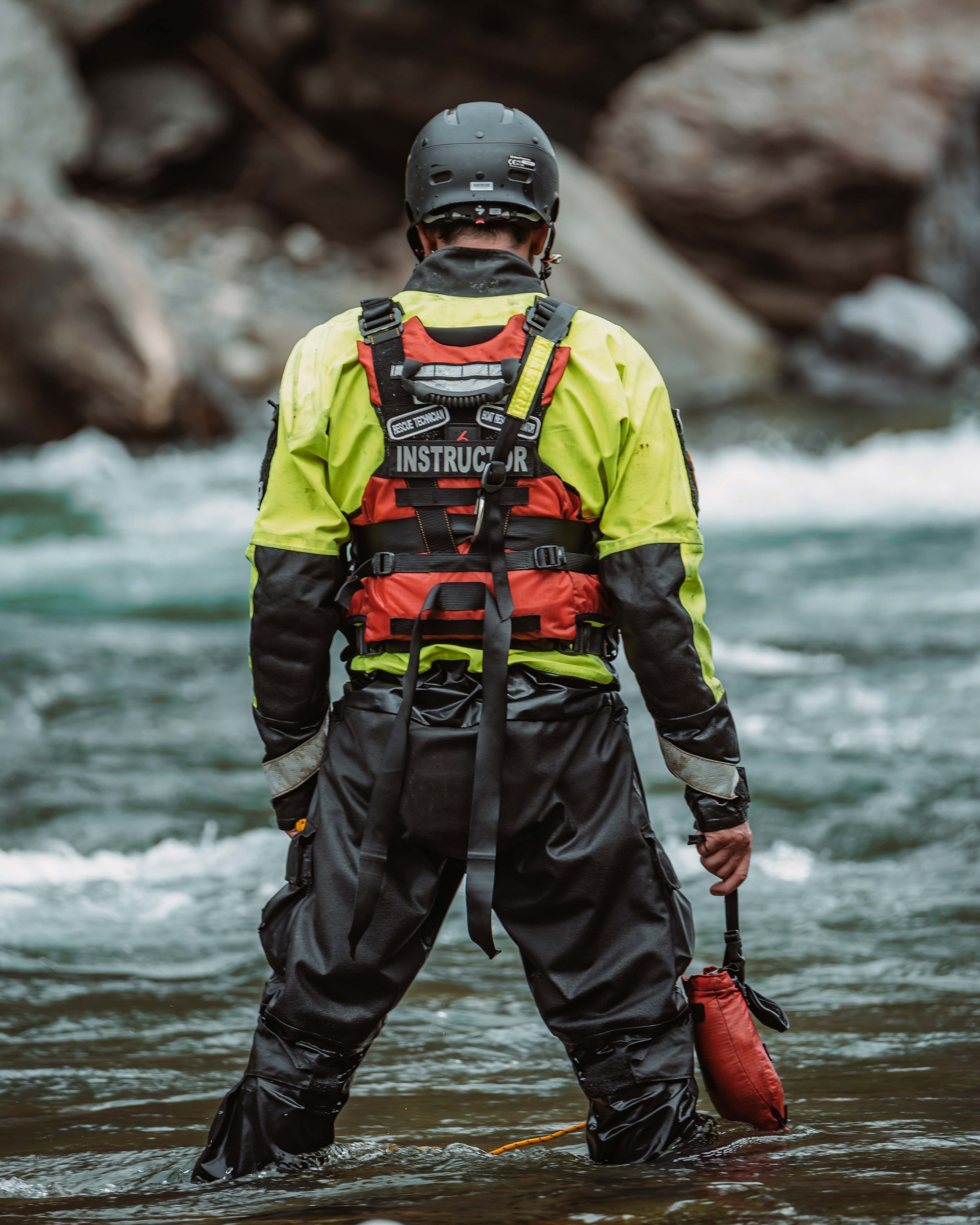 Instructor helping a climber check her harness and rope during rope rescue training