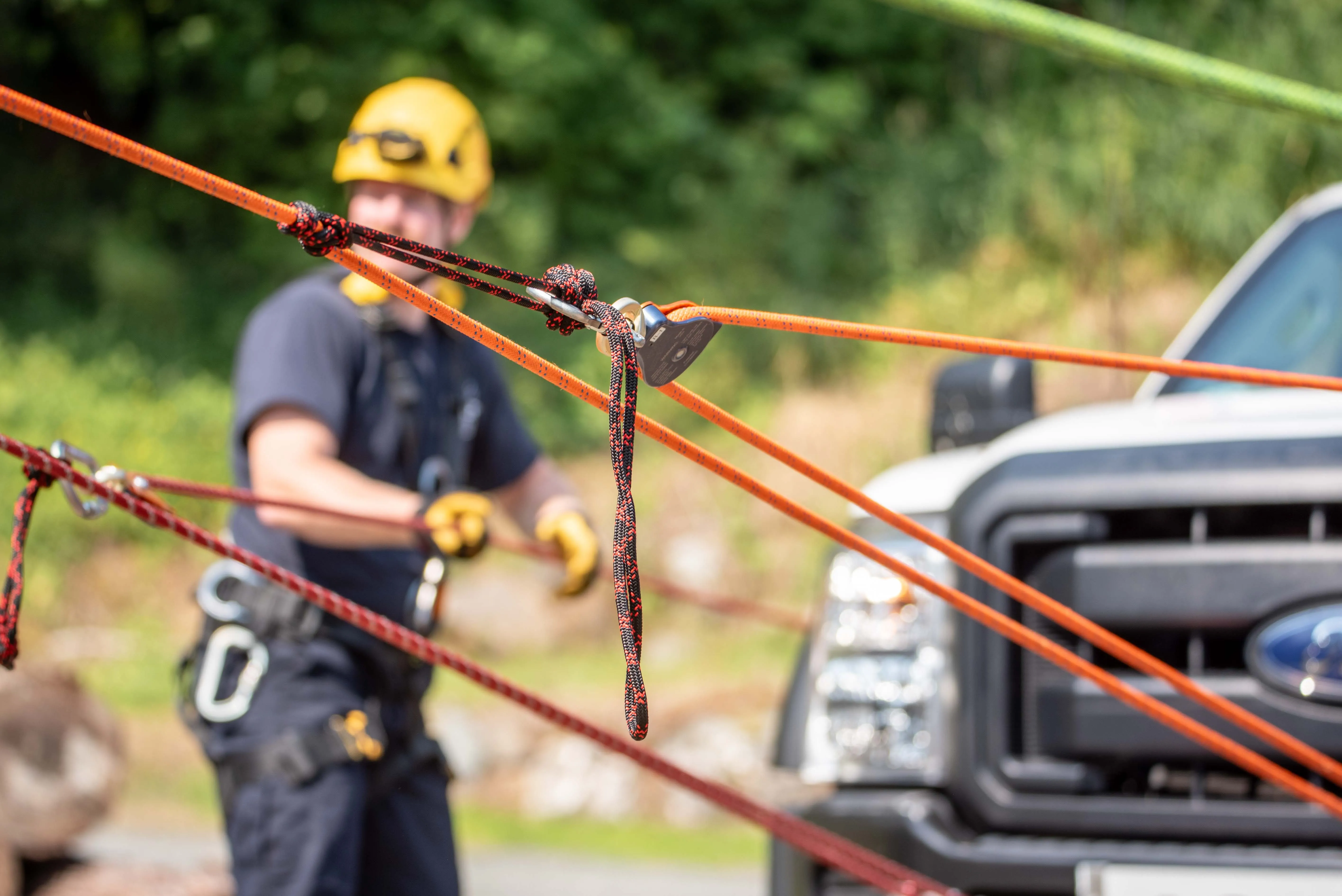 Instructor helping a climber check her harness and rope during rope rescue training