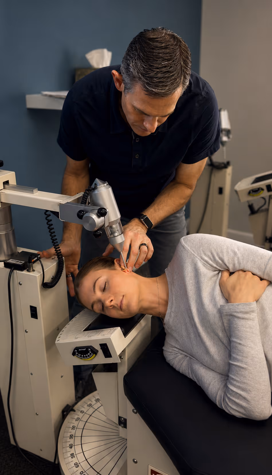 Dr. Lavender delivering a precise upper cervical Atlas Orthogonal adjustment on a treatment table.