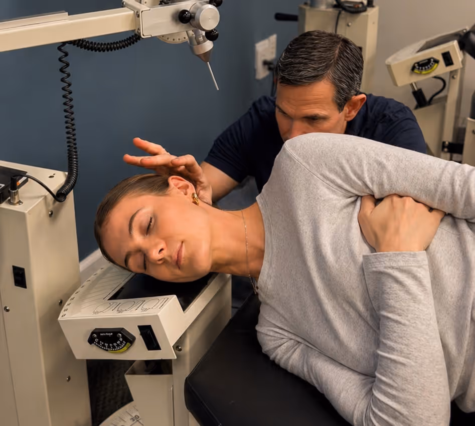 Dr. Lavender delivering a precise upper cervical Atlas Orthogonal adjustment on a treatment table.