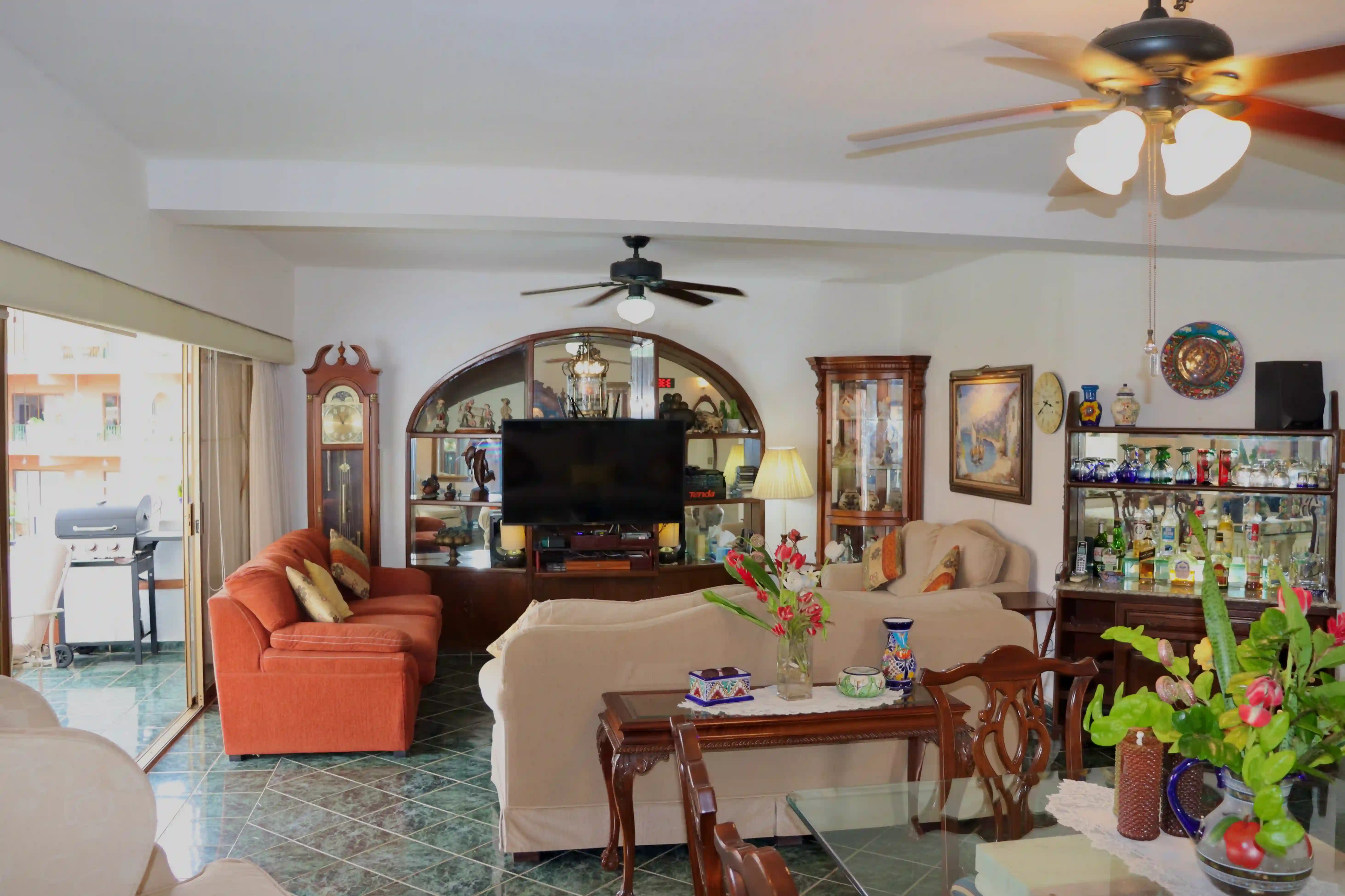 Wide-angle view of the open-concept living and dining room in Marina Vallarta, highlighting the polished tile floors and the classic architectural layout.