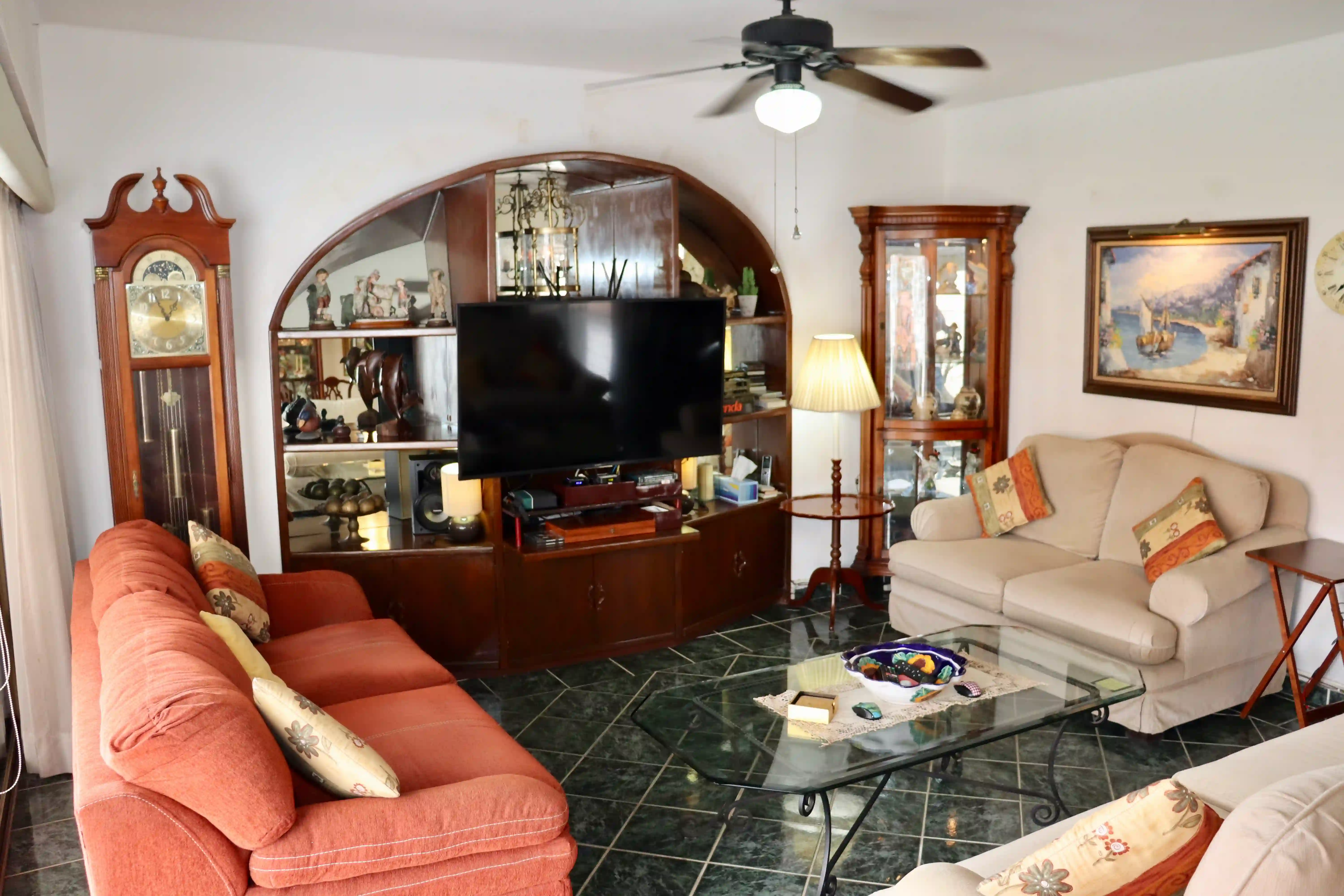 Spacious lounge area with large sliding glass doors opening to a terrace, showcasing the bright and airy atmosphere of this coastal condo.
