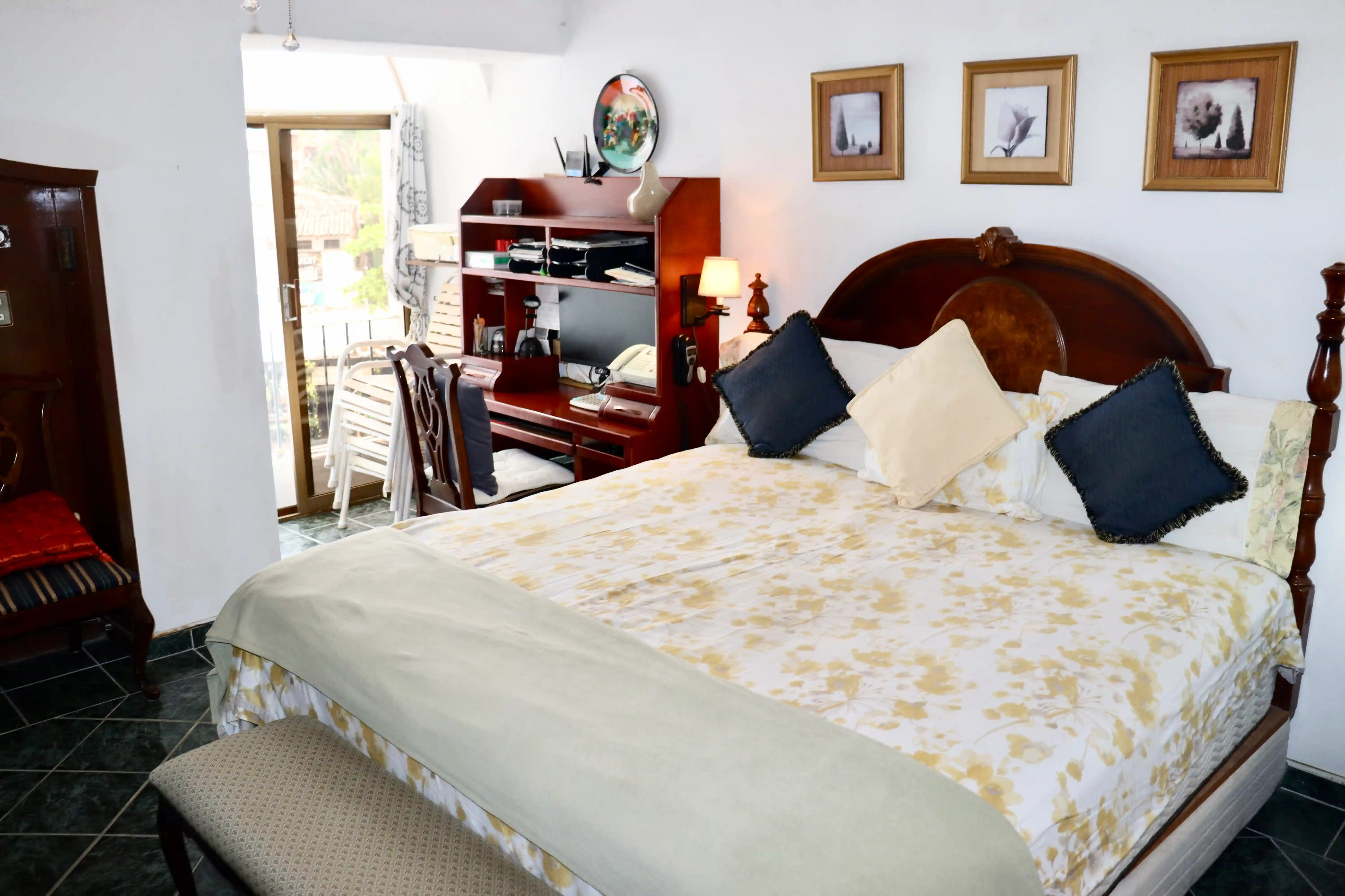 Interior view of the first bedroom at Royal Pacific, showcasing the spacious layout, classic Mexican decor, and warm ambient lighting.