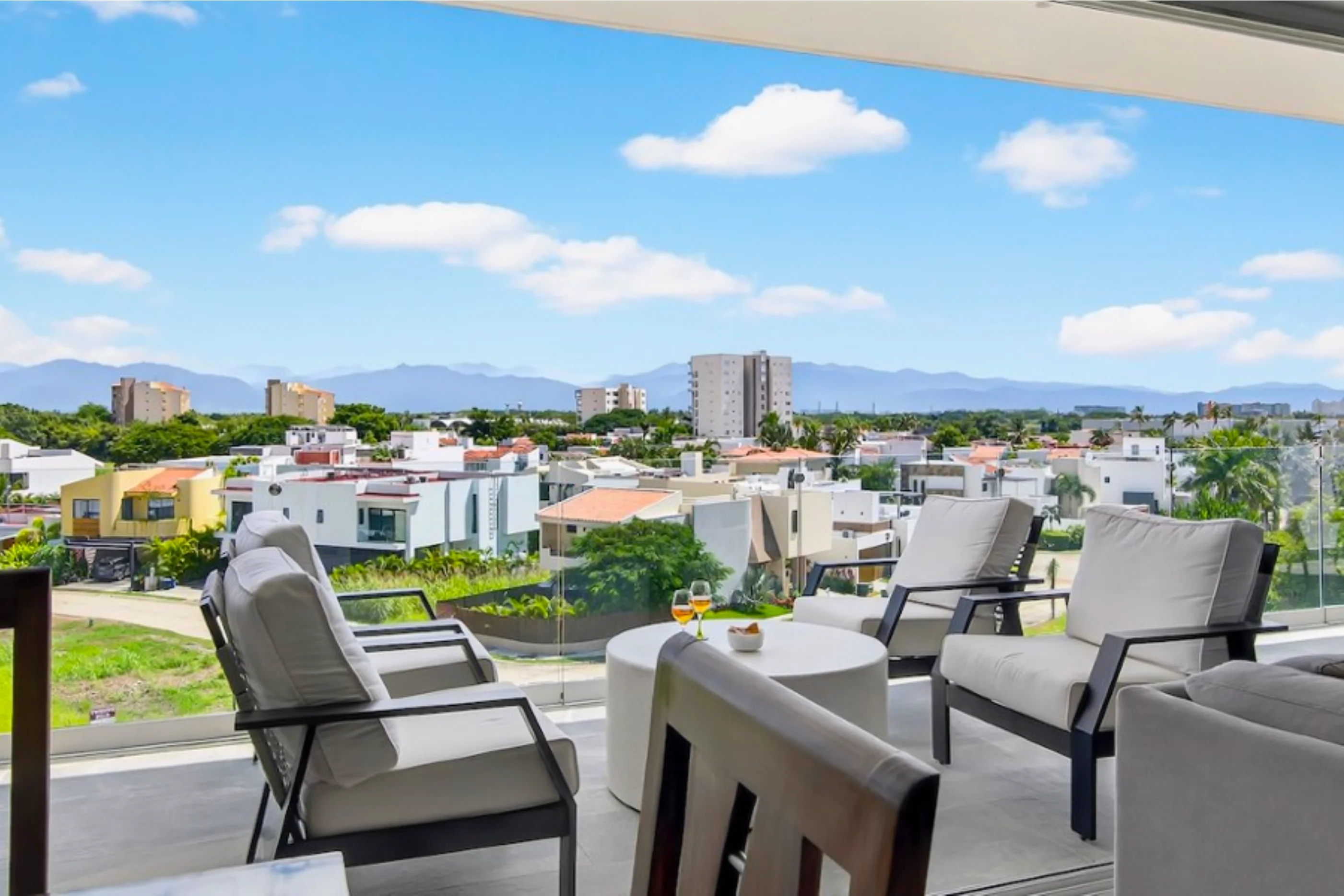 Stunning ocean and mountain view from the private balcony of Believe 401 C in Flamingos, featuring modern glass railings and a tropical horizon.