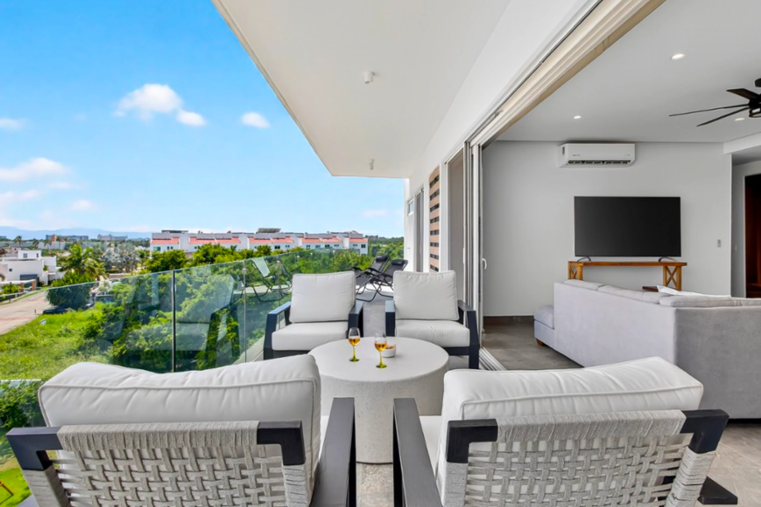 Wide-angle sunset view from a high-floor balcony in Flamingos, showcasing the coastal landscape and upscale residential area of Nuevo Vallarta.