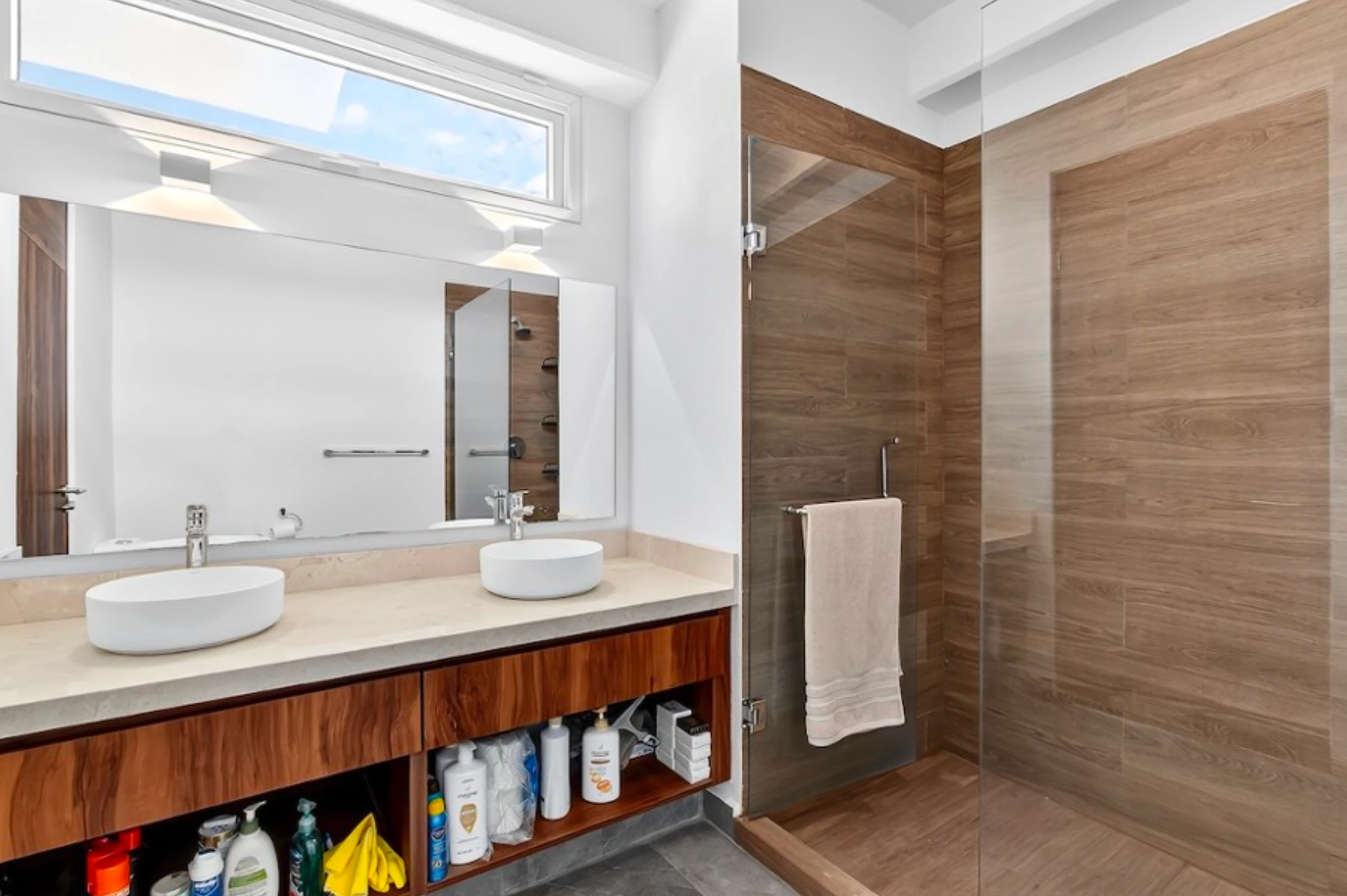 Luxury bathroom design with marble-patterned tiling, a modern glass shower, and high-quality contemporary fixtures.
