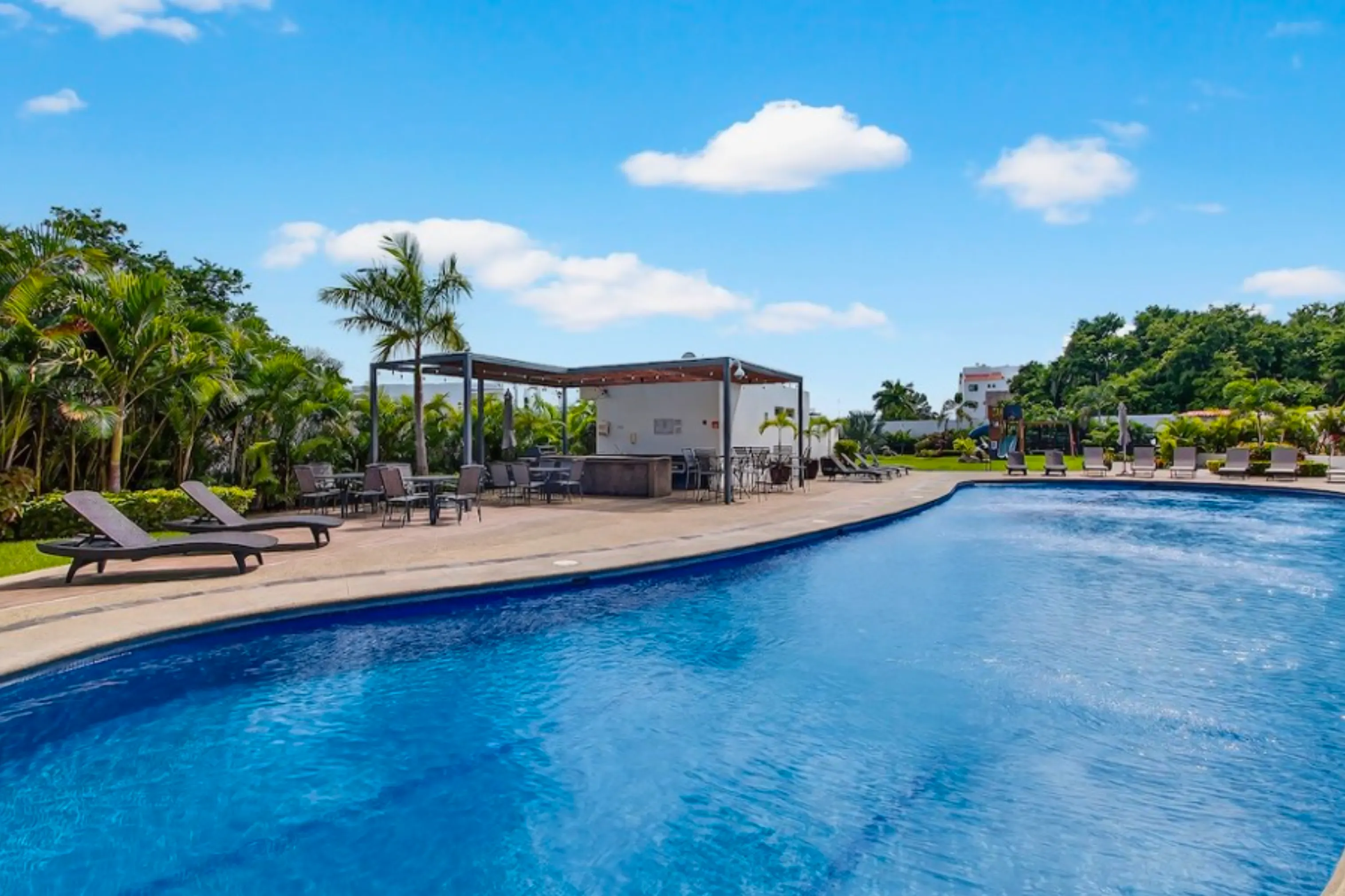 Incredible rooftop infinity pool at Believe Flamingos, offering panoramic ocean views and a luxury lounge area for residents.