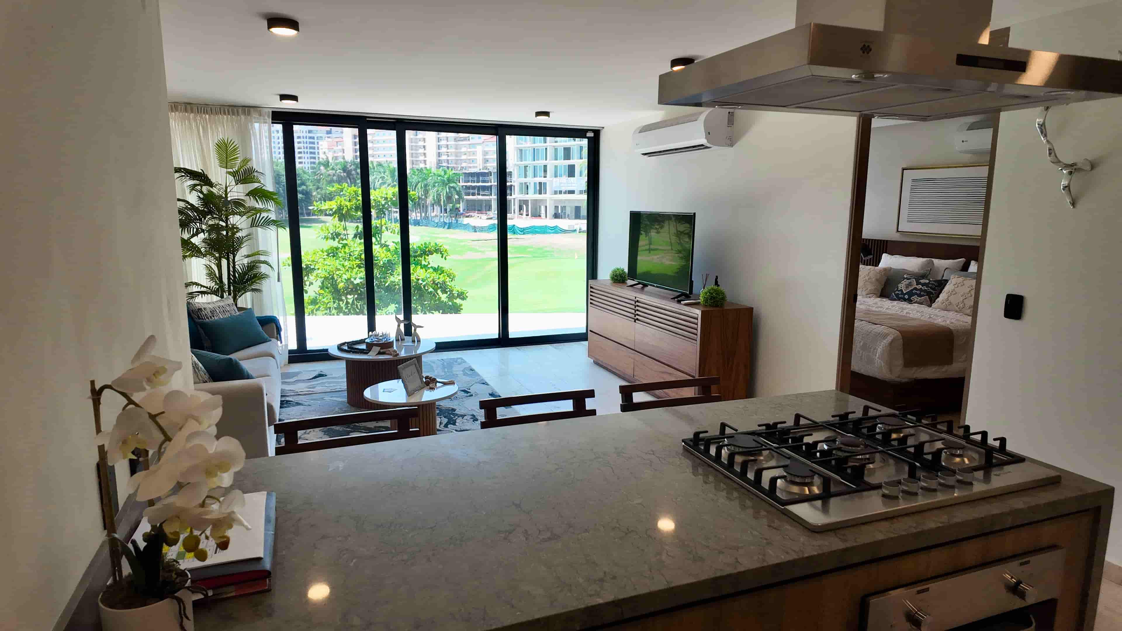 Full perspective of the modern kitchen and living space, showcasing premium finishes and sophisticated turn-key furniture.