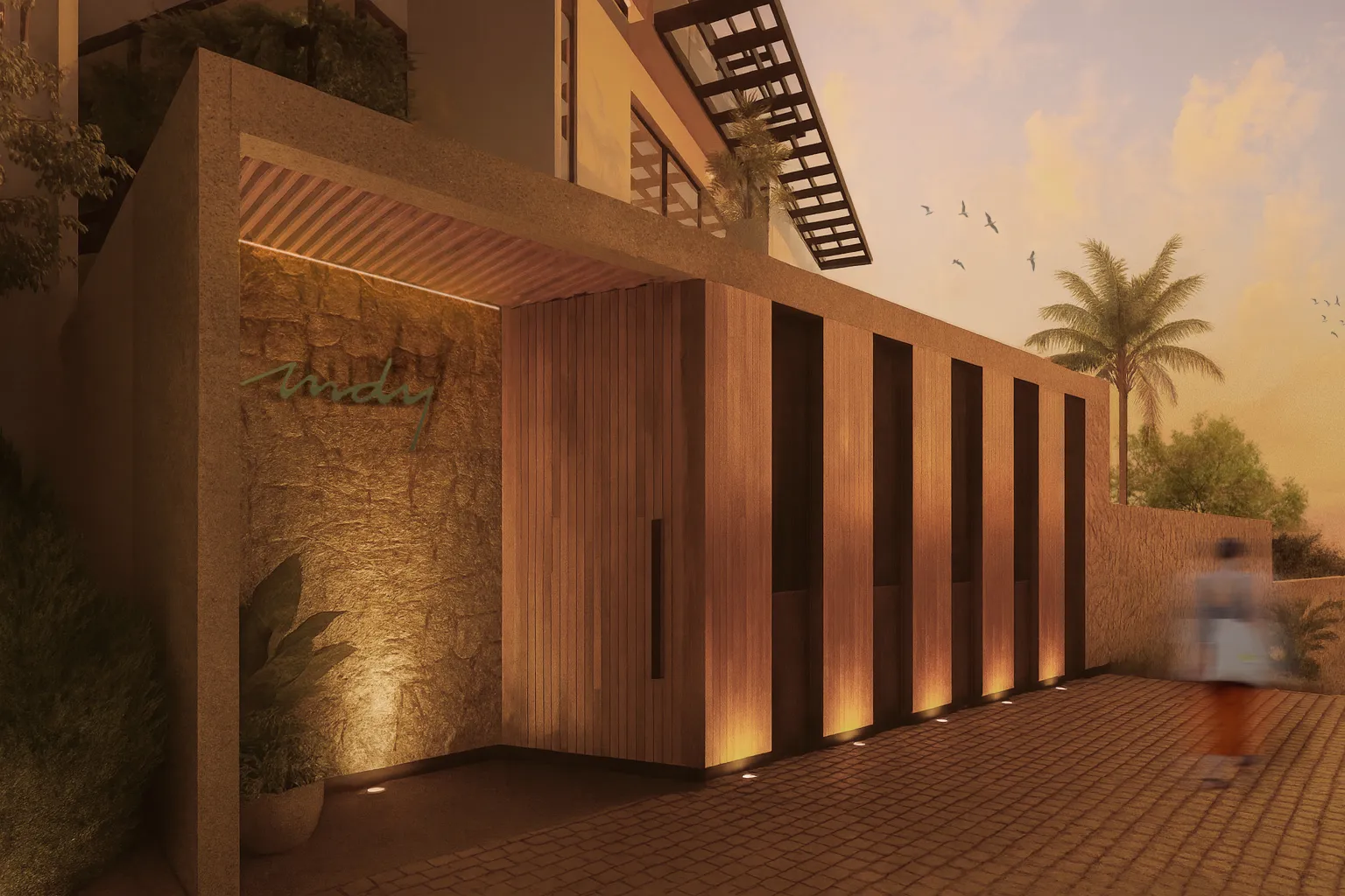 Luxury pedestrian entrance with illuminated wood finishes at night for the MDY residential complex, located in the exclusive North Hotel Zone of Vallarta.