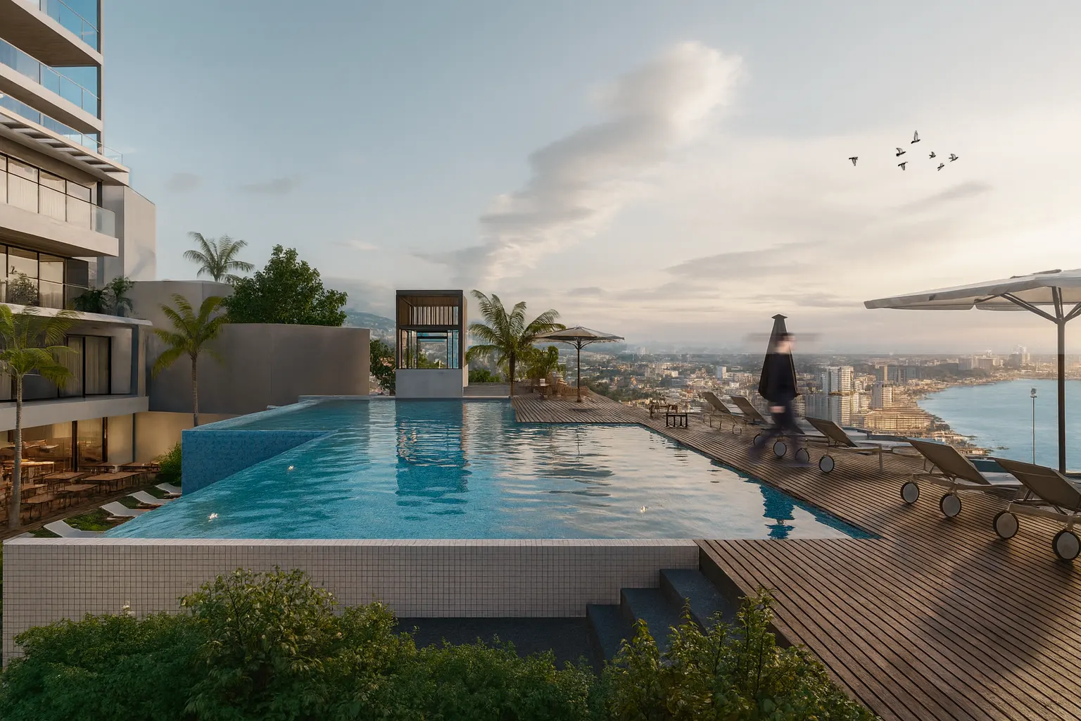 Rooftop infinity pool with lounge chairs and umbrellas during the day at MDY, the new premium development with world-class amenities in Vallarta.