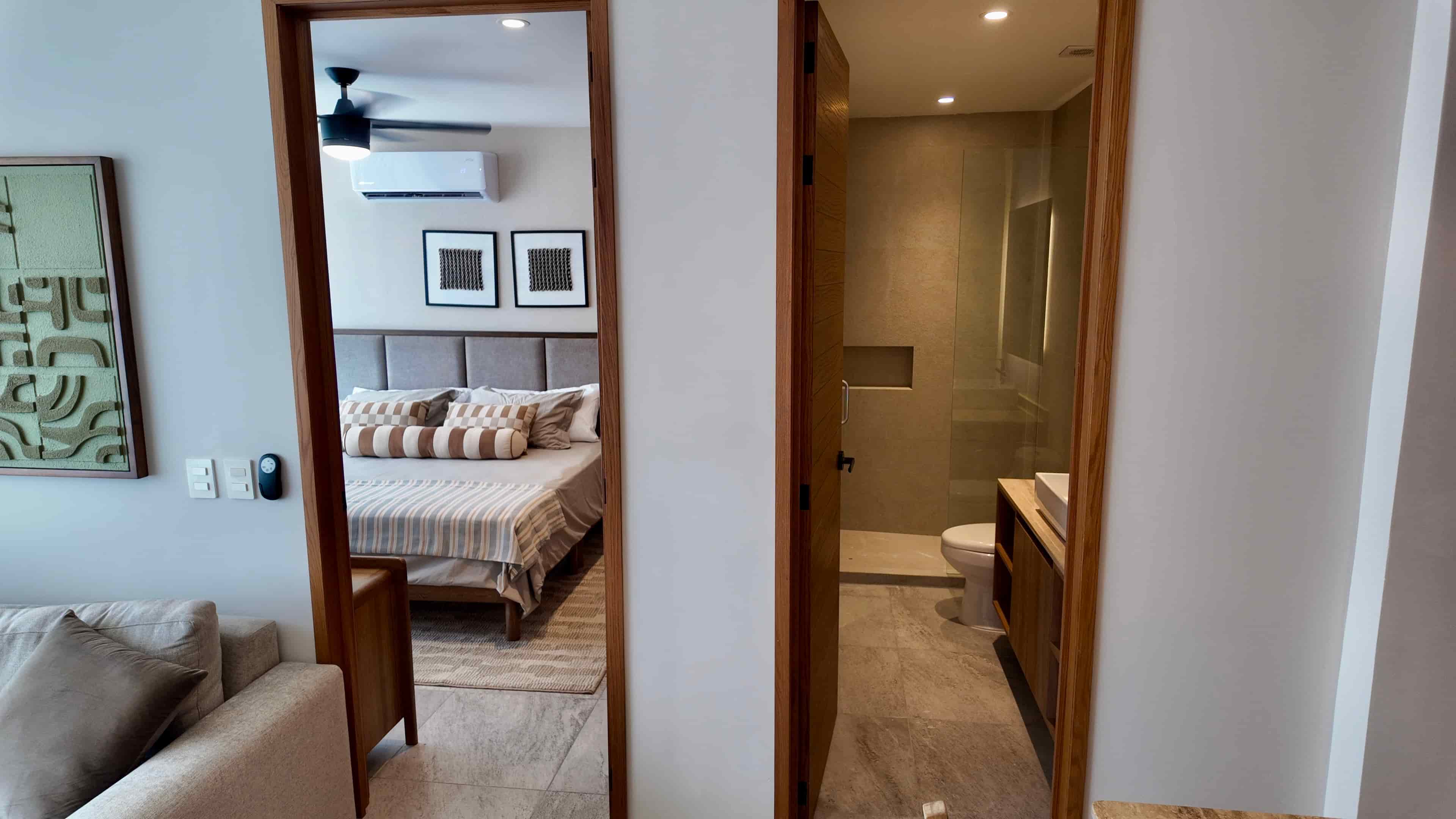 View from a master suite bedroom in TERRA 242 looking down the hallway past the en-suite luxury bathroom entrance.