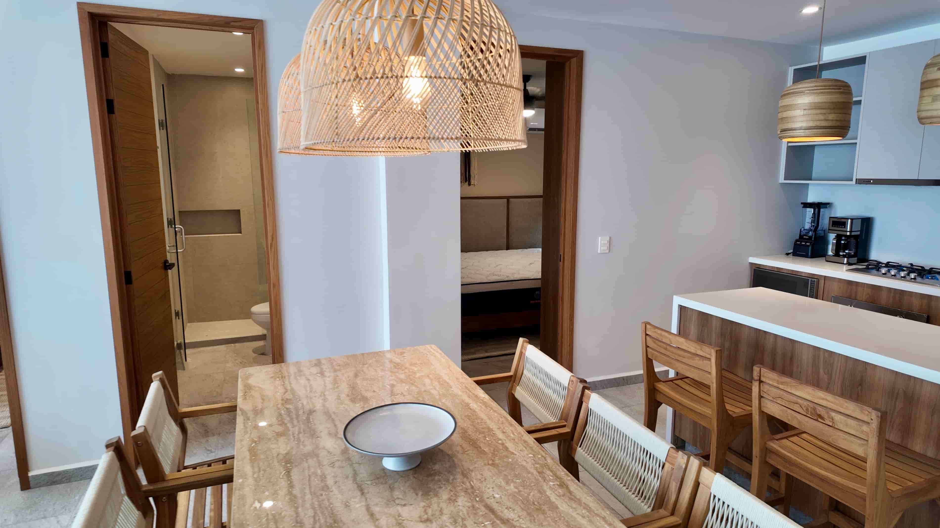Dining area perspective focusing on contemporary wooden furniture, woven light fixtures, and close proximity to the TERRA 242 kitchen.