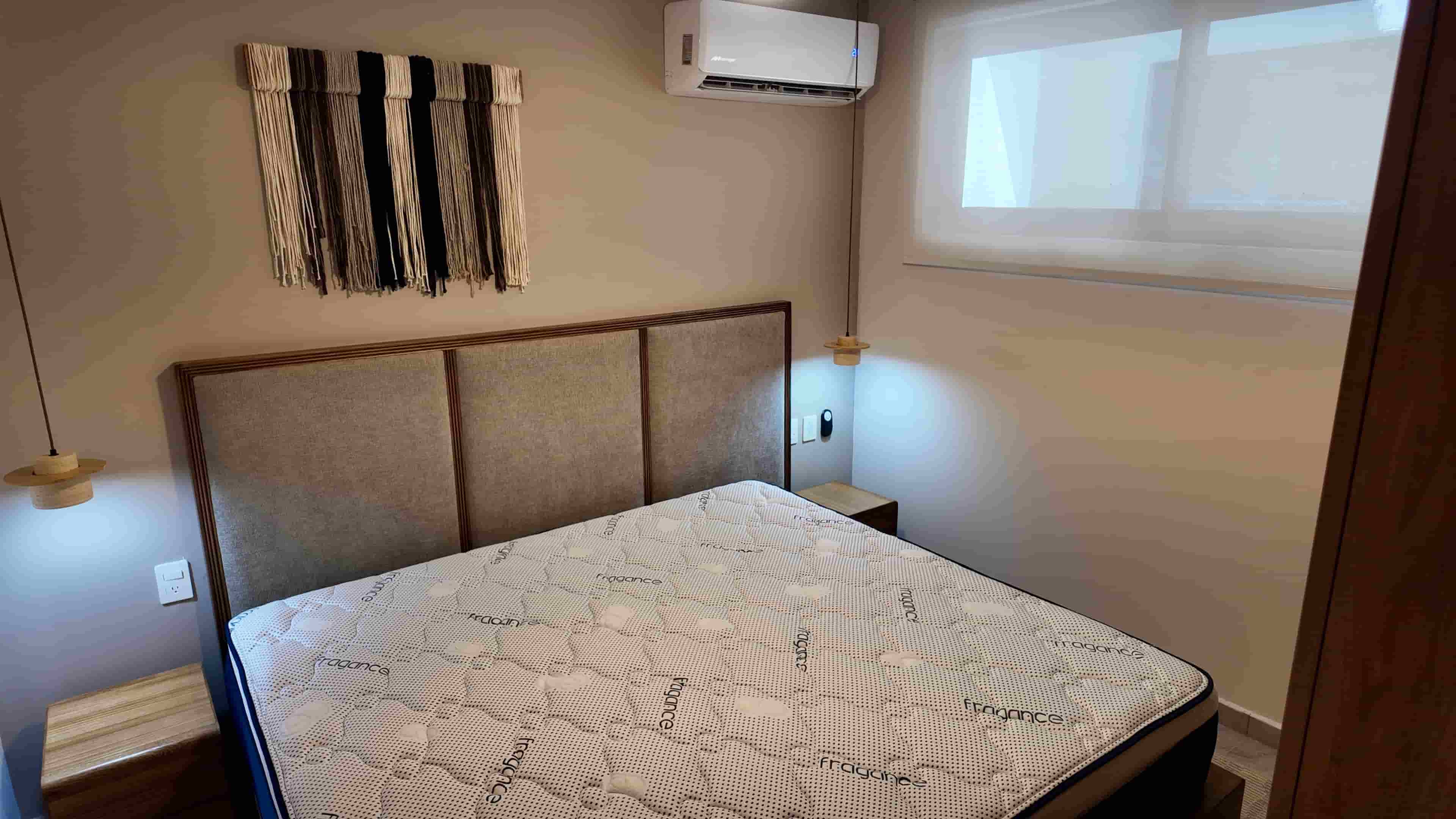 Secondary bedroom or guest suite layout in TERRA 242 with clean bedding and strategic accent lighting for a comfortable stay.