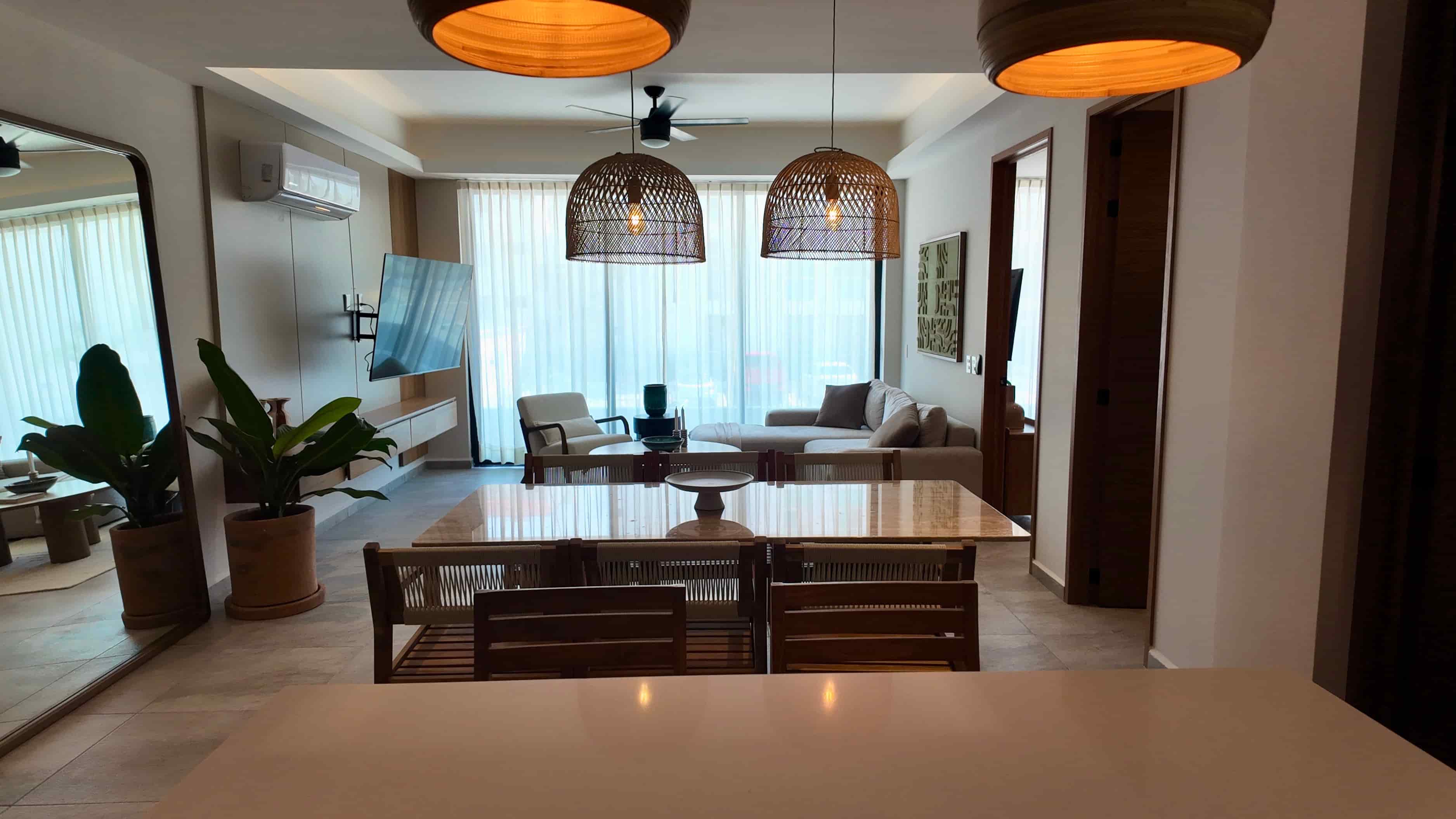 Elegant dining room setting framed by decorative lighting fixtures, highlighting a high-end interior feel at TERRA 242.