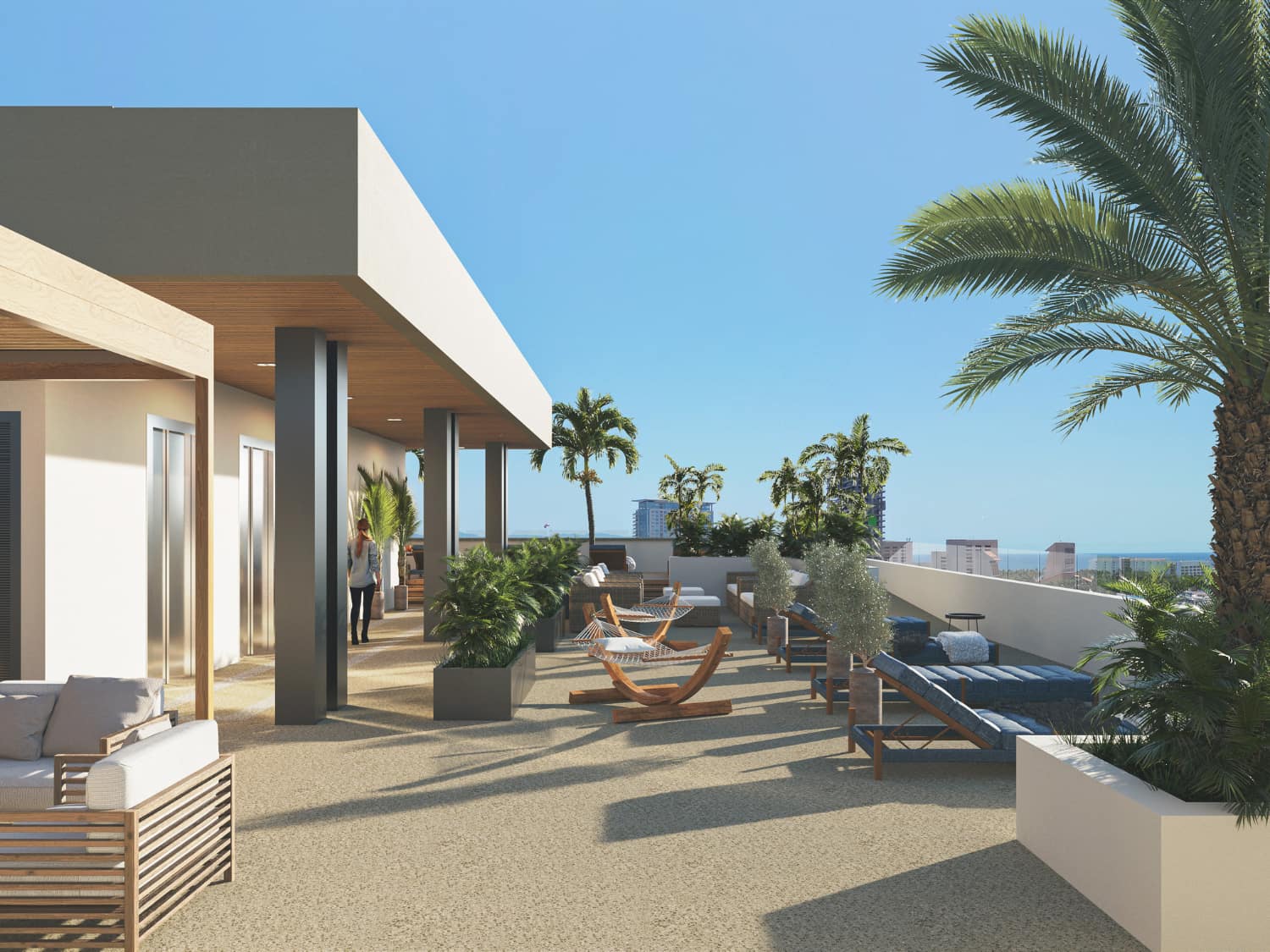 Open-air rooftop deck with lounge furniture and tropical landscaping at DUE