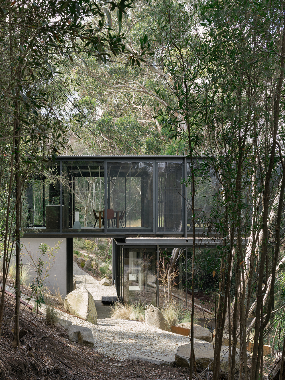 prefabricated steep site fully glazed facade exposed timber ceiling