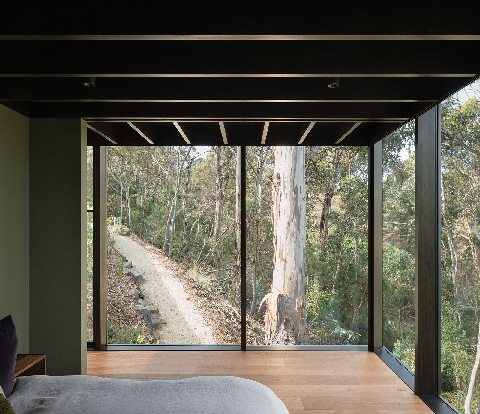 prefabricated steep site fully glazed facade exposed timber ceiling