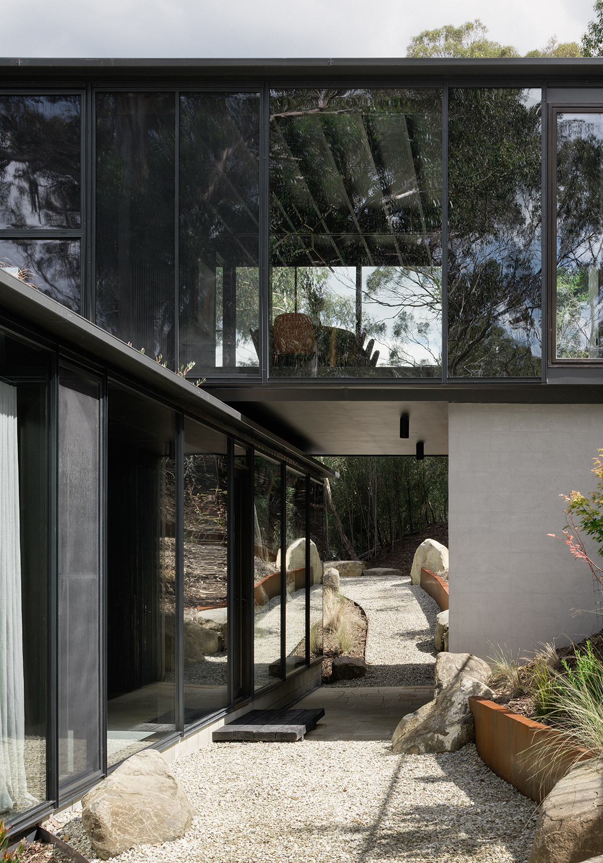 prefabricated steep site fully glazed facade exposed timber ceiling wildlife corridor