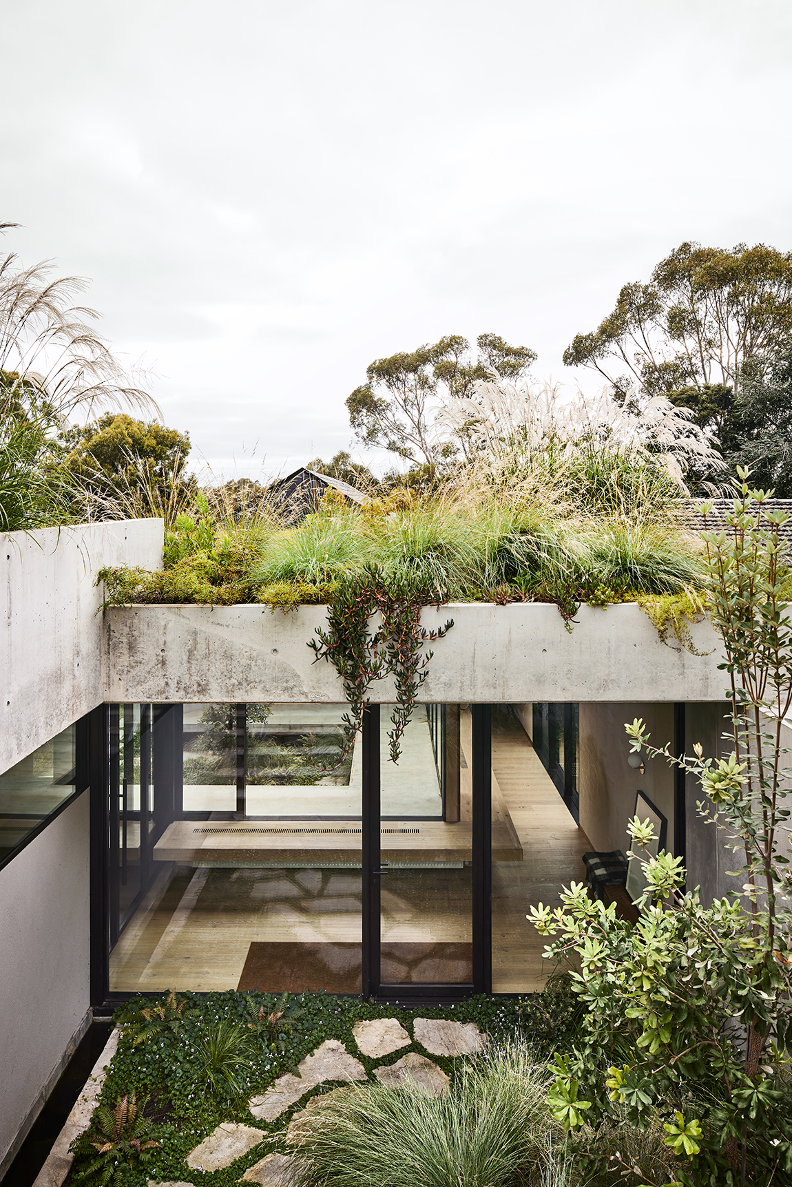concrete house nestled into landscape