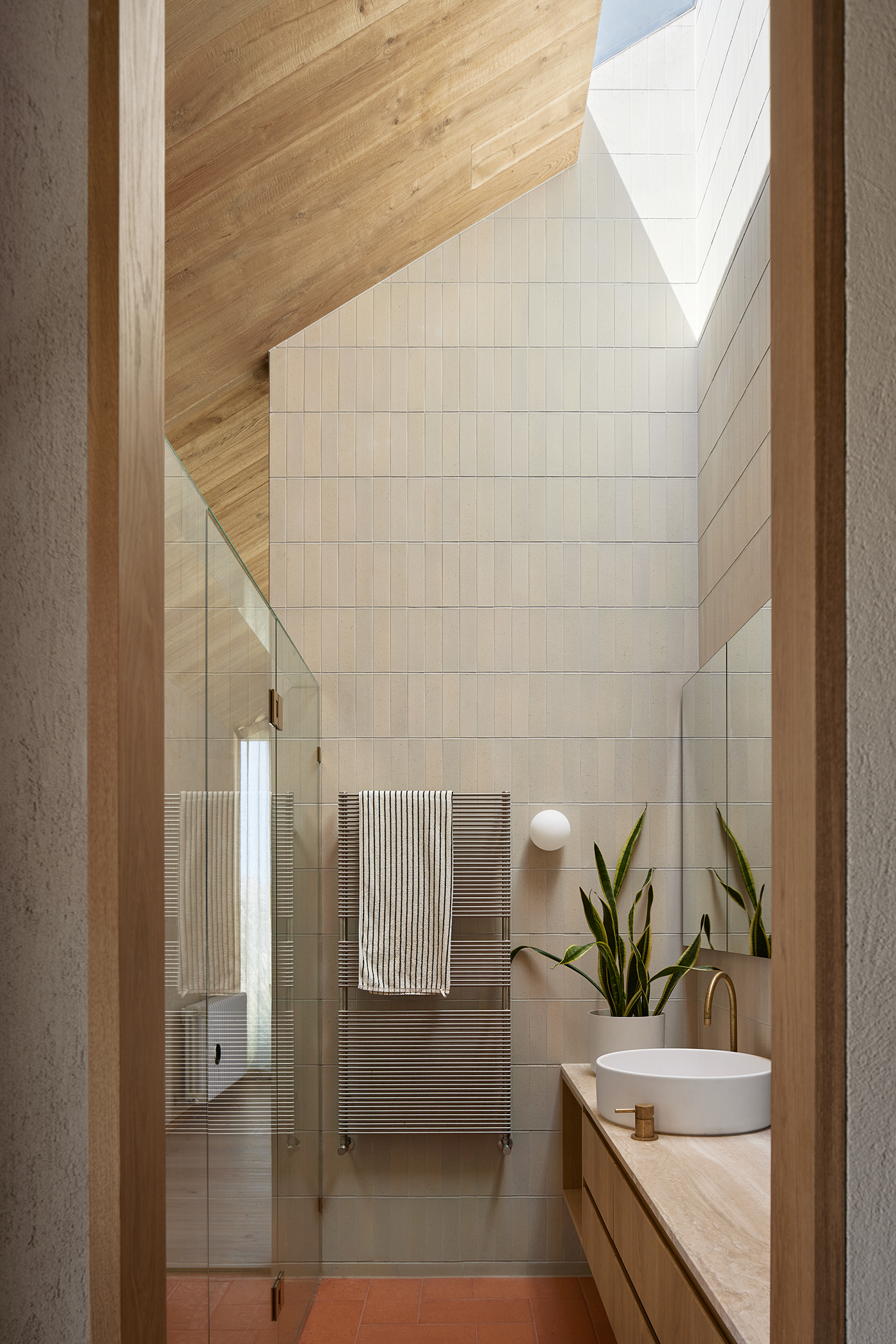 pitched ceiling in bathroom with skylight