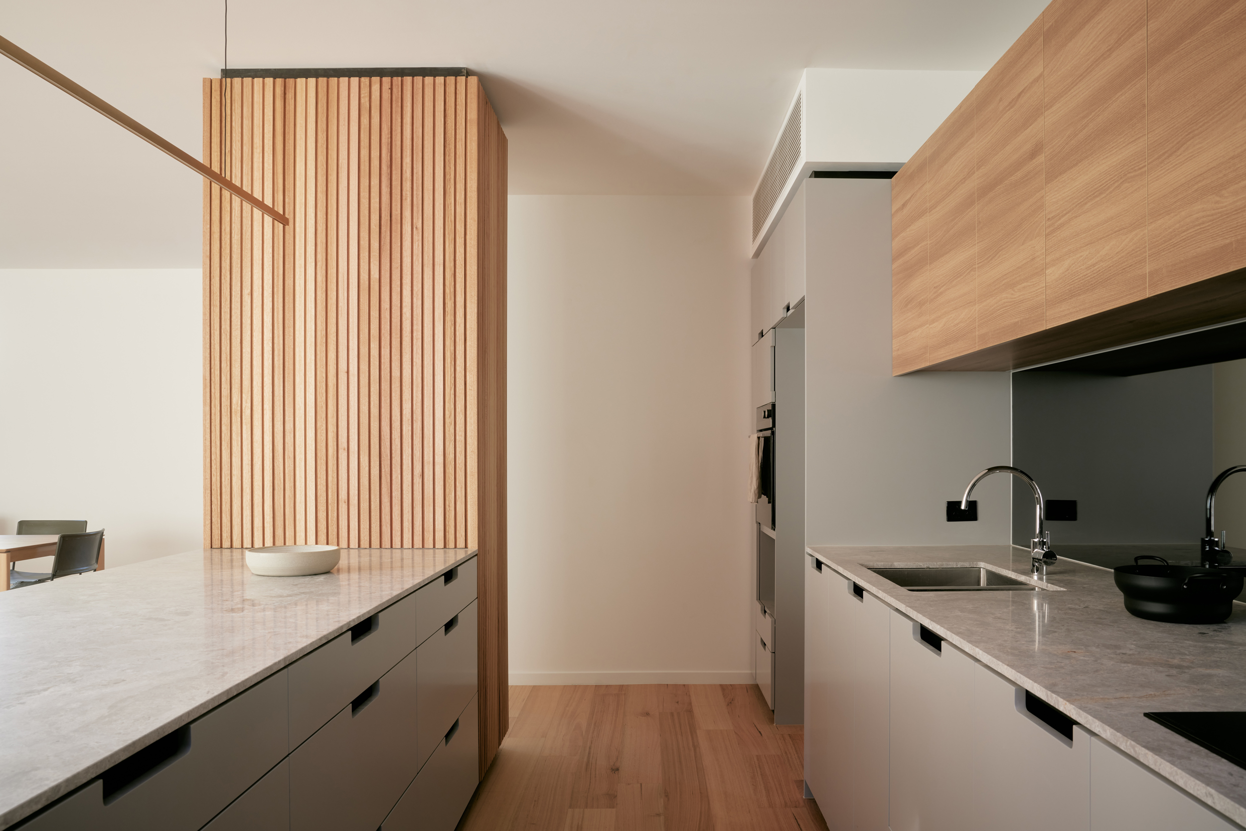 timber joinery in kitchen with brass pendant over kitchen island
