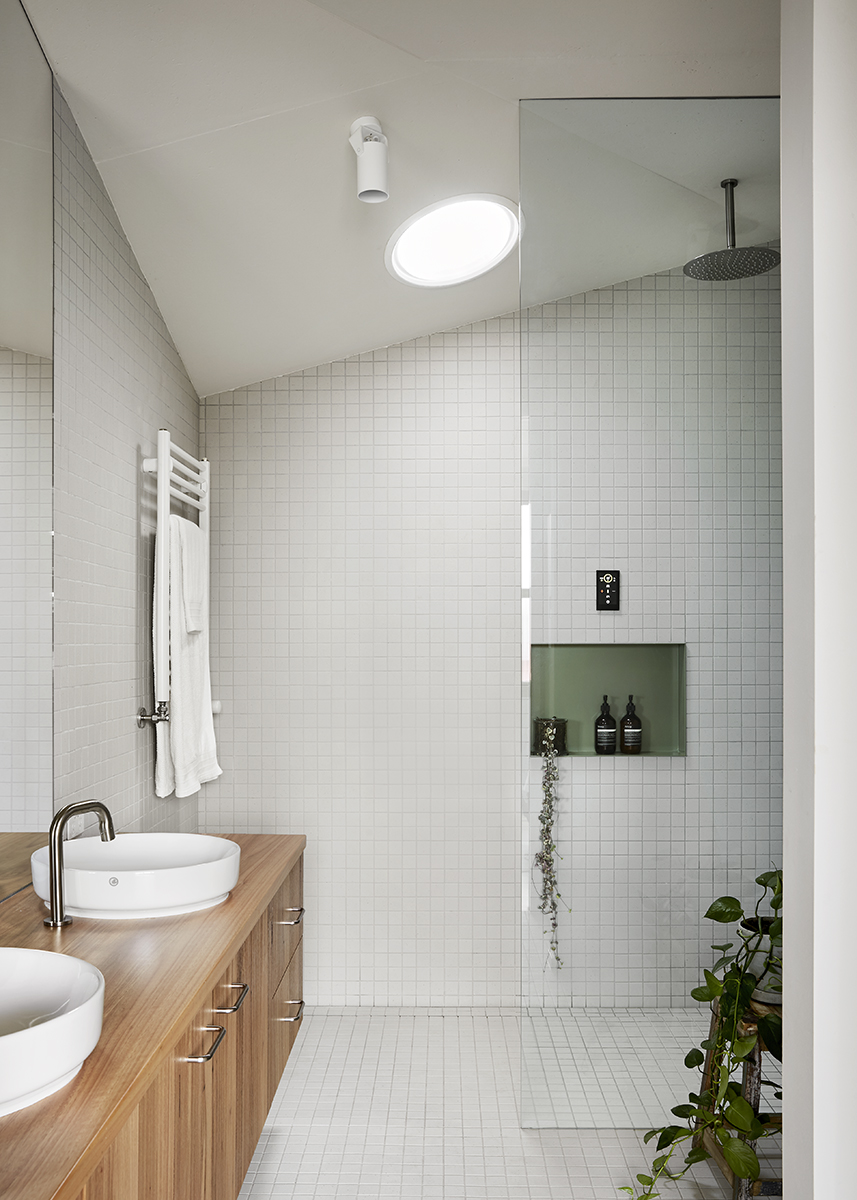 bright bathroom dual sinks full height shower