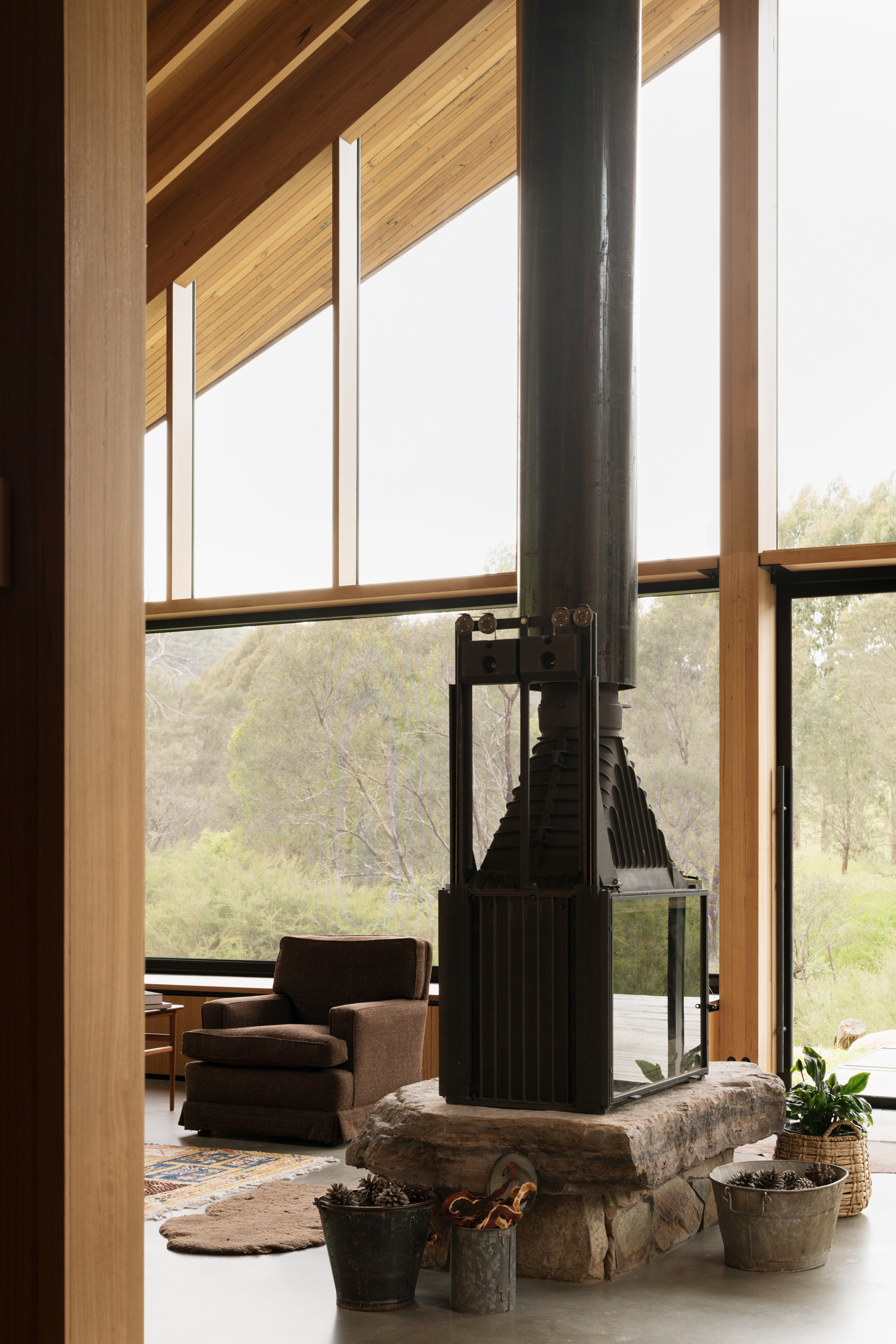 fireplace set on rock in centre of living room