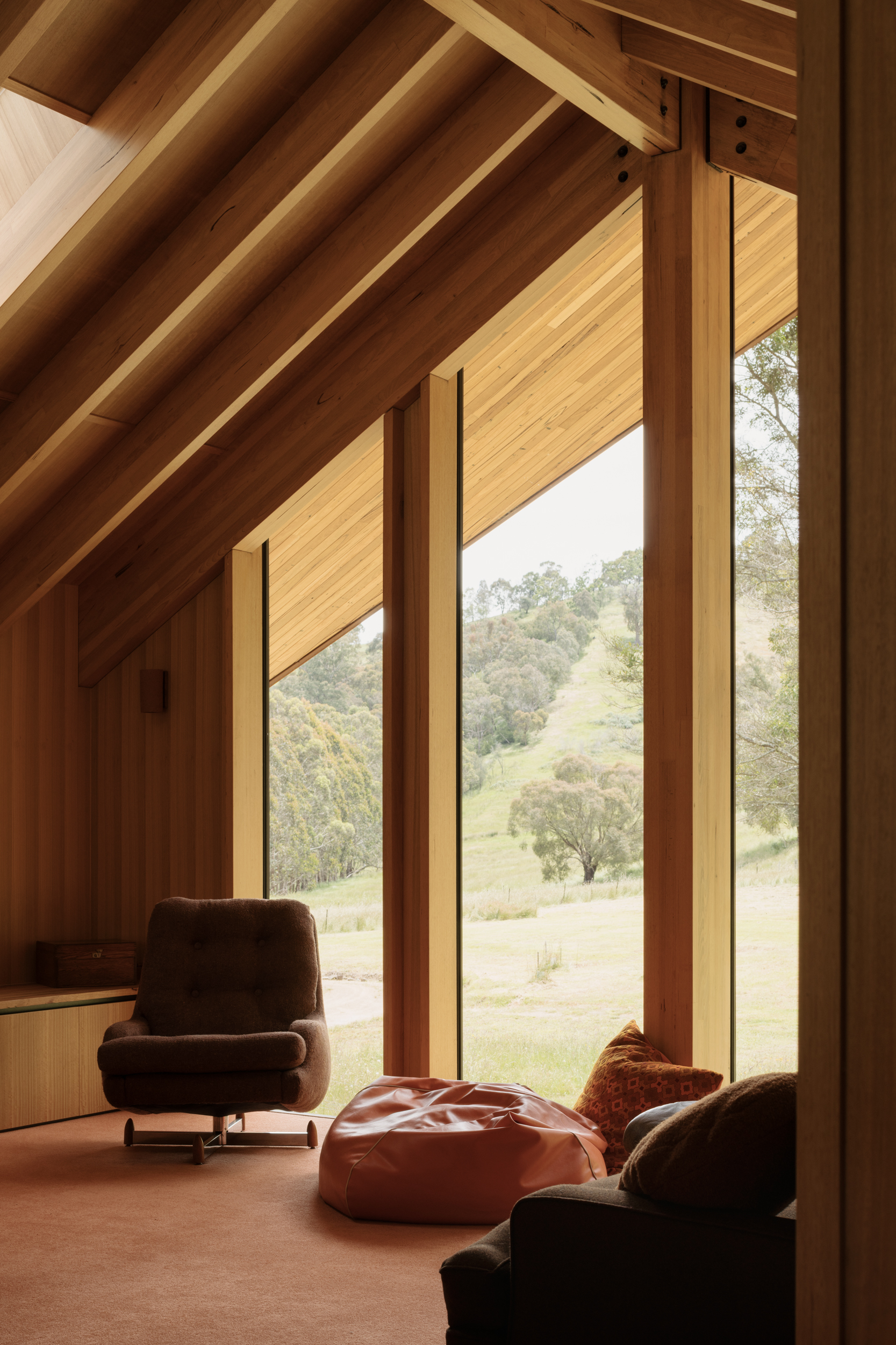 concrete floor, exposed timber ceiling and full height glazing in this unique regional house by archier
