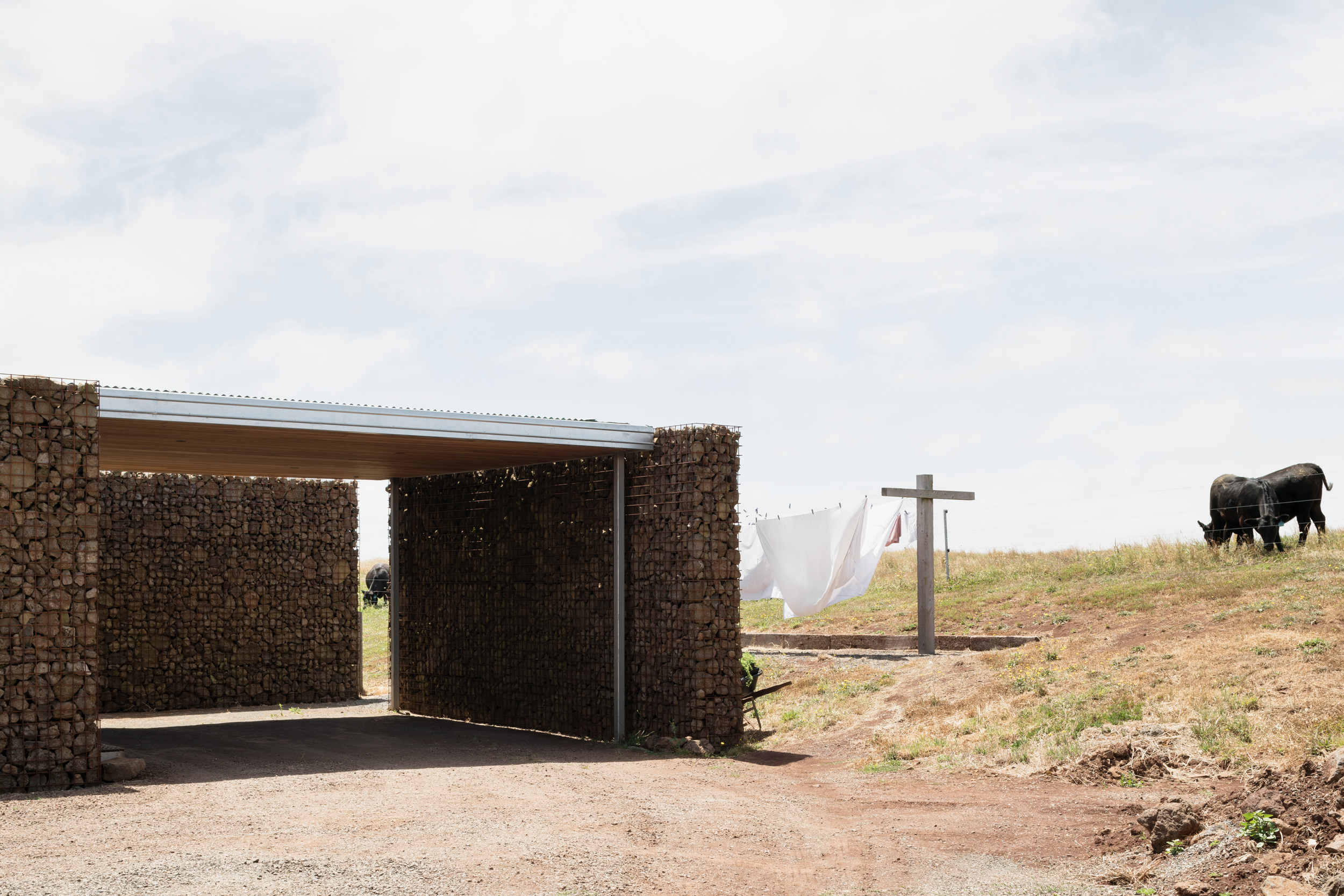 gabion wall sheltering a productive garden and providing separation from farm
