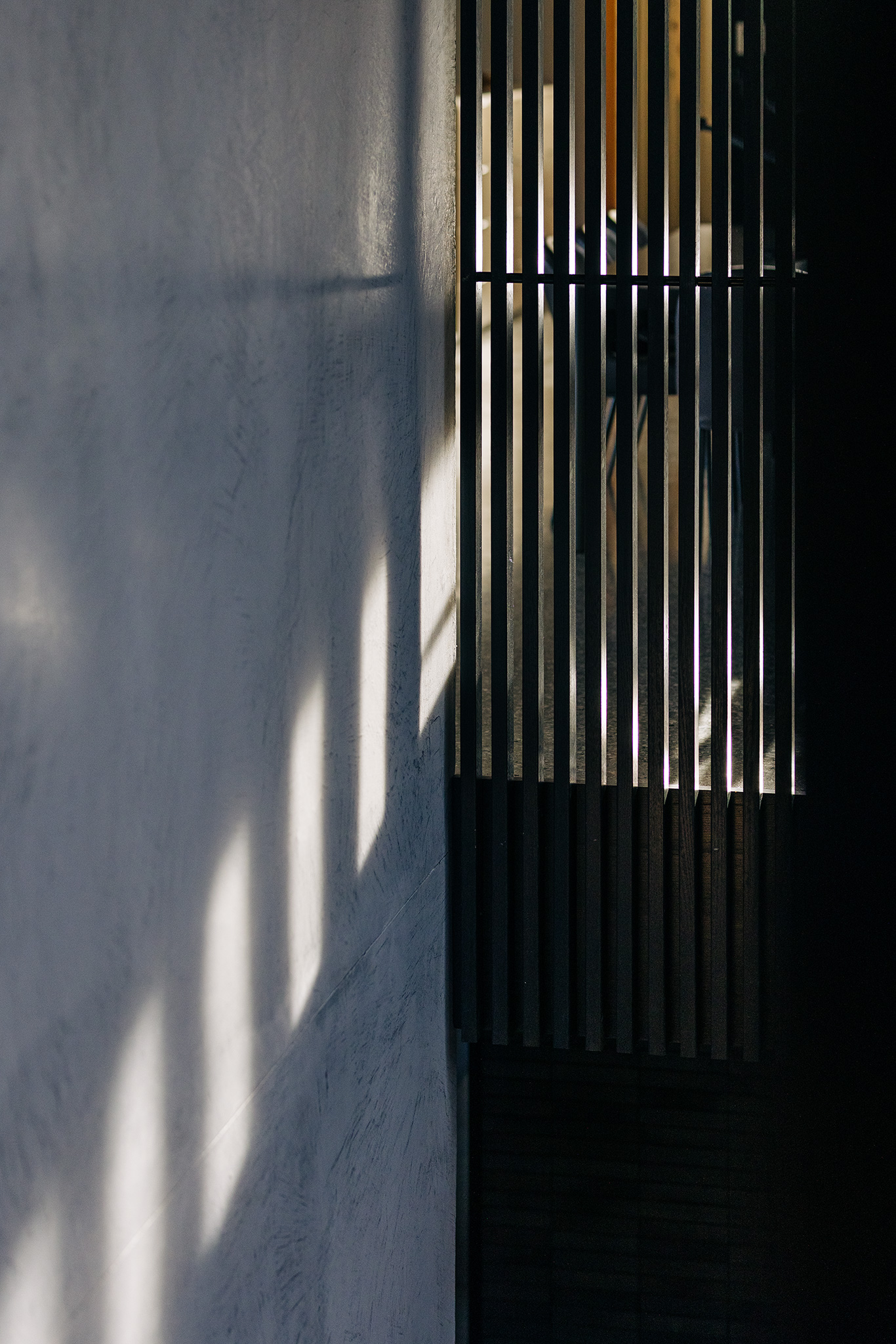 light and shadow play on walls from timber batten screen