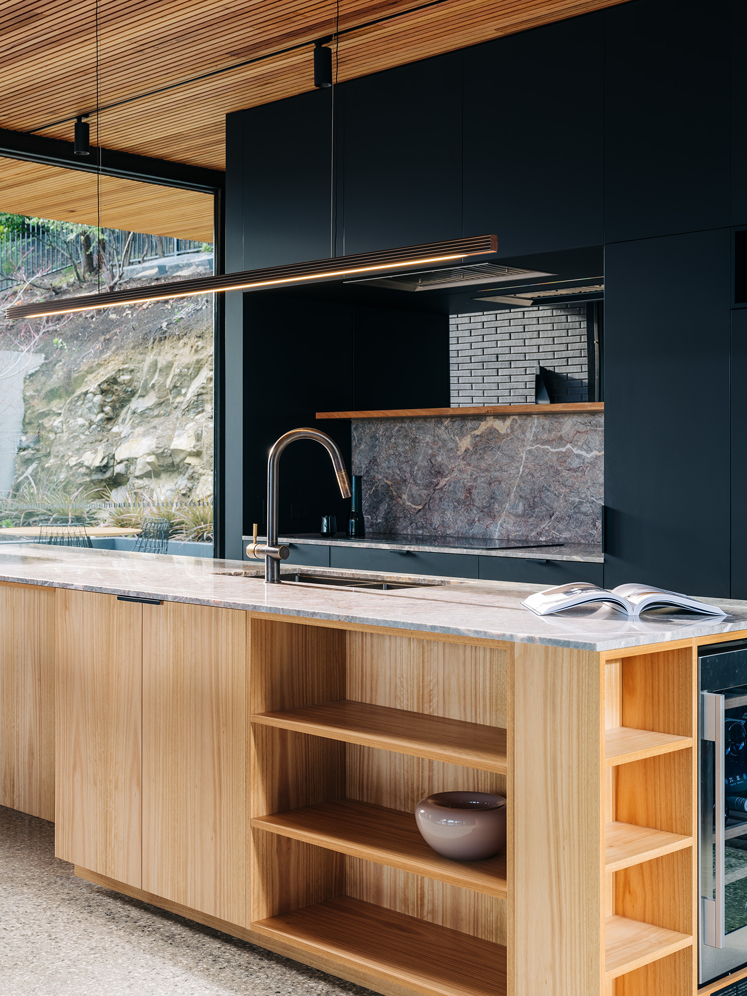 brass capital pendant over island bench