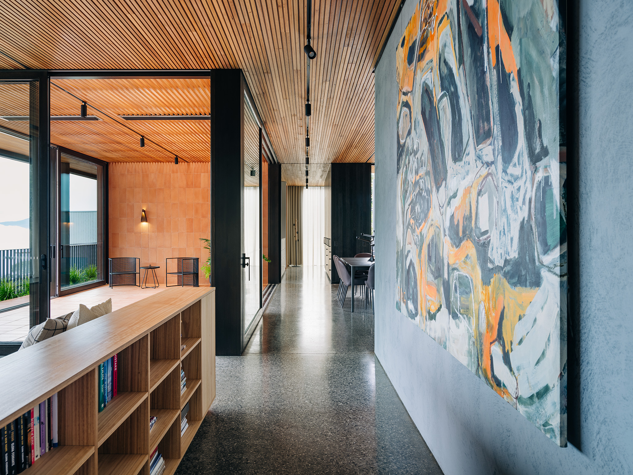 large artwork on wall, looking towards upper balcony