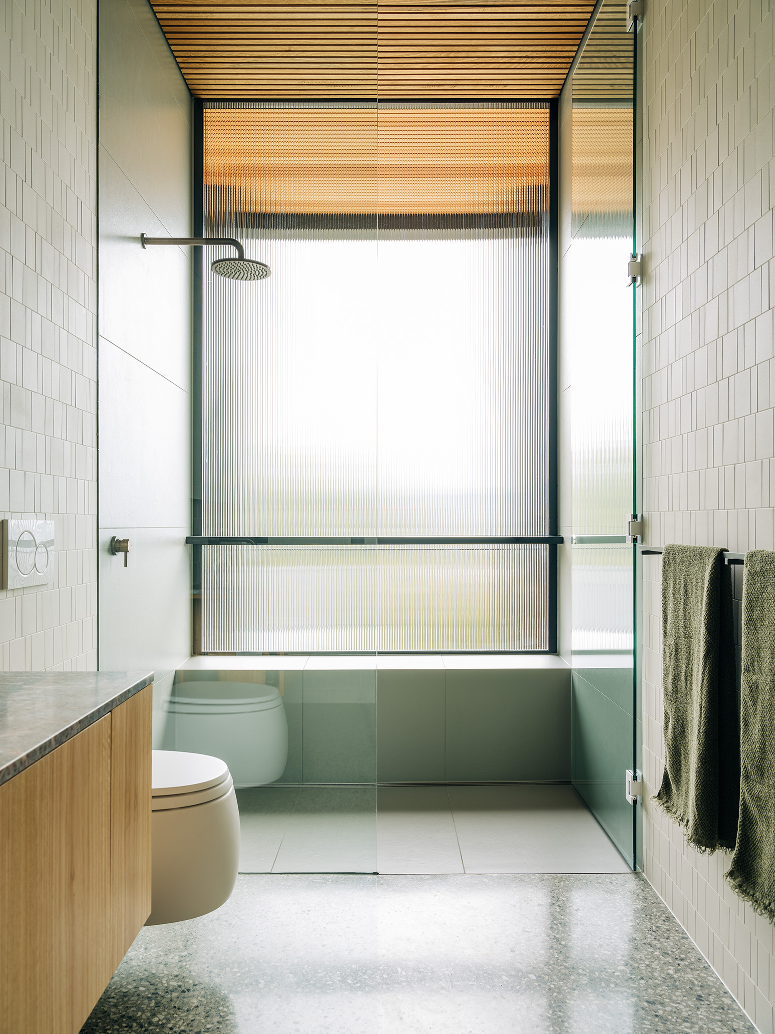 light filled bathroom with floating toilet