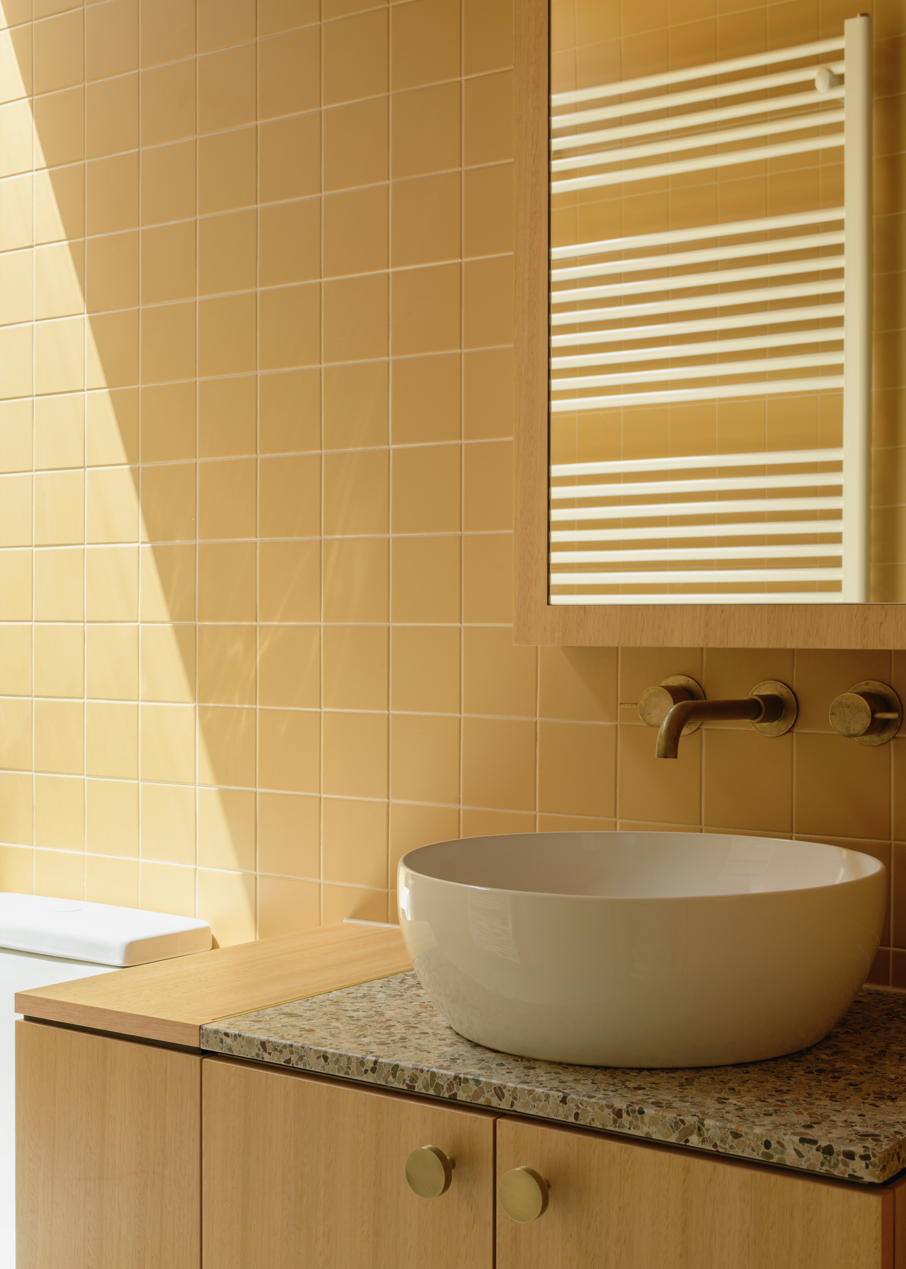 soft yellow tiled bathroom