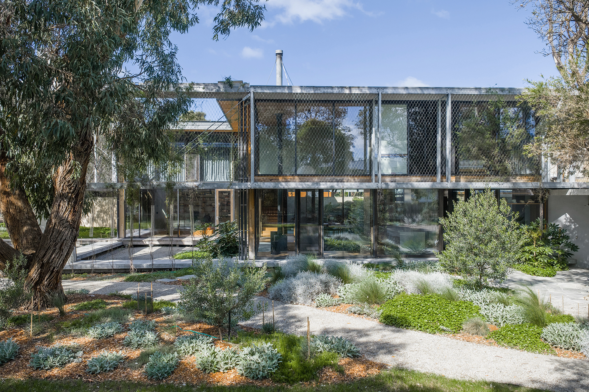 two storey house connected to landscape green roof