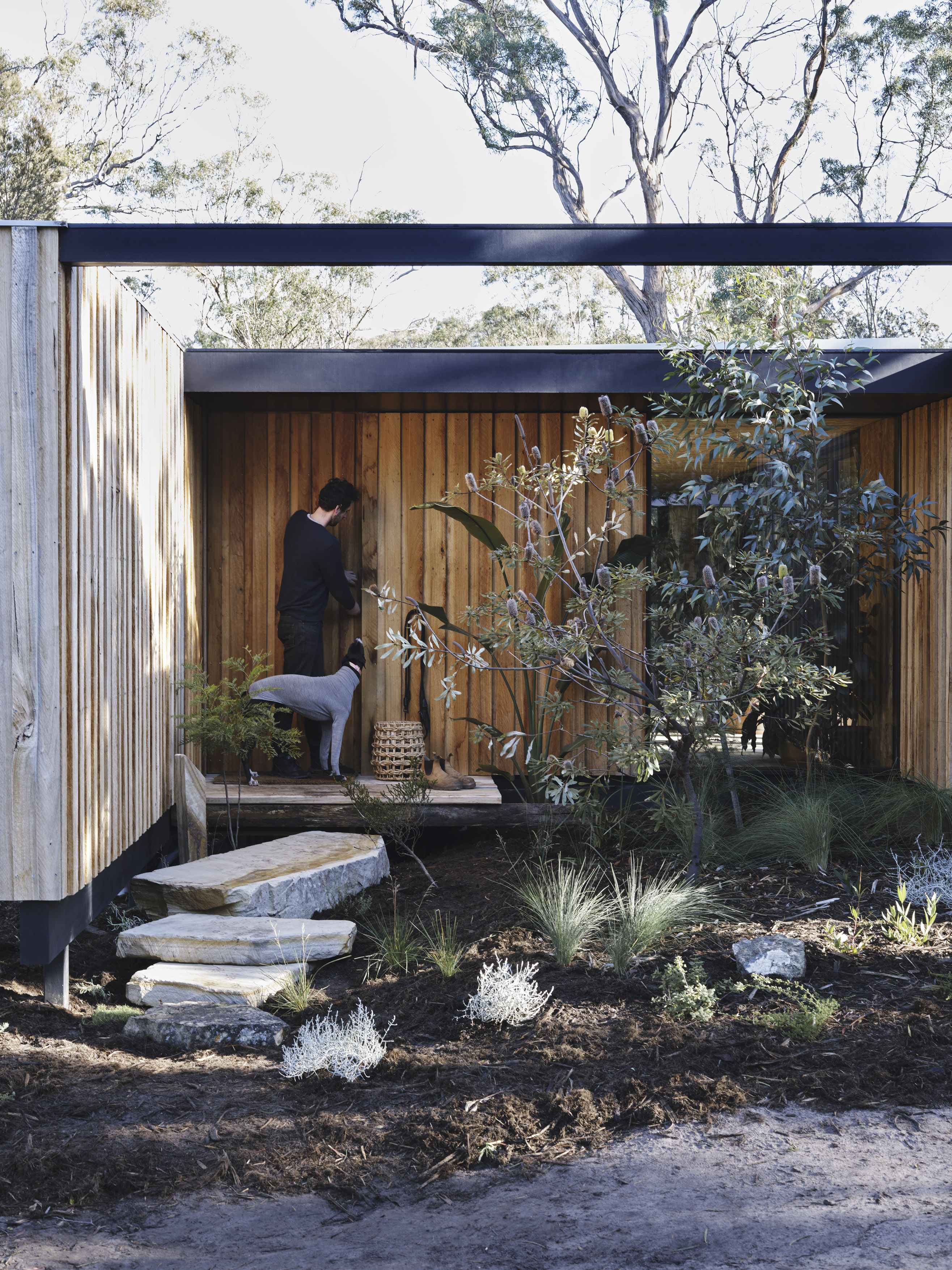 architectural timber cabin with sandstone steps to entry