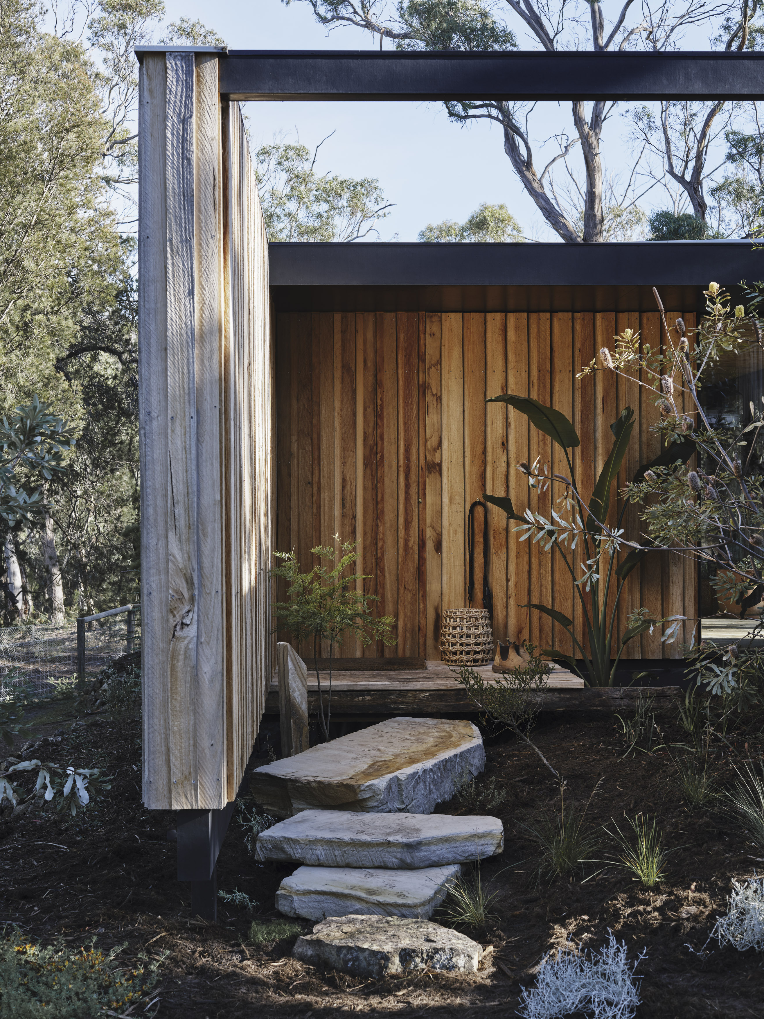 architectural timber cabin with sandstone steps to entry