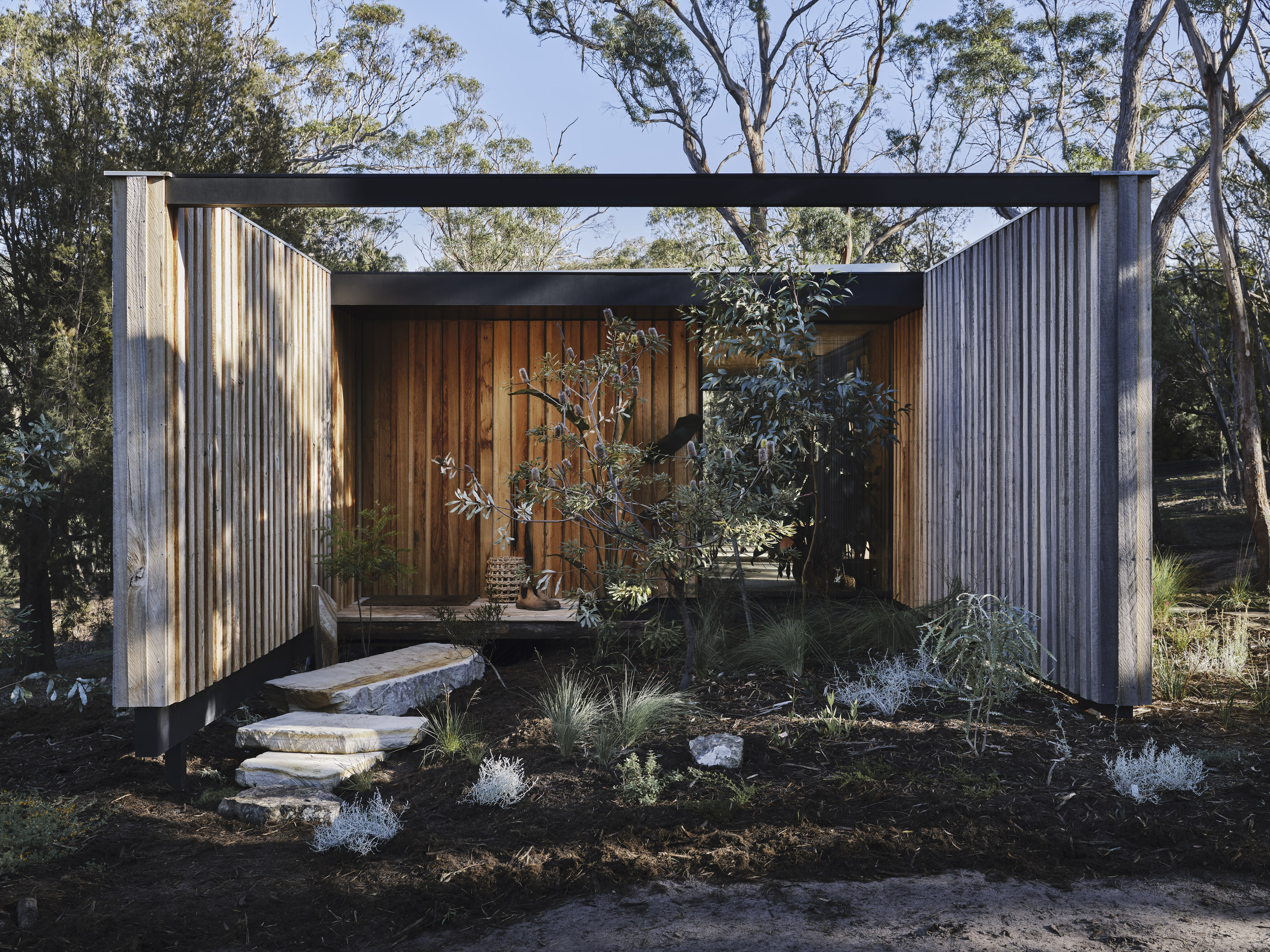 architectural timber cabin with sandstone steps to entry