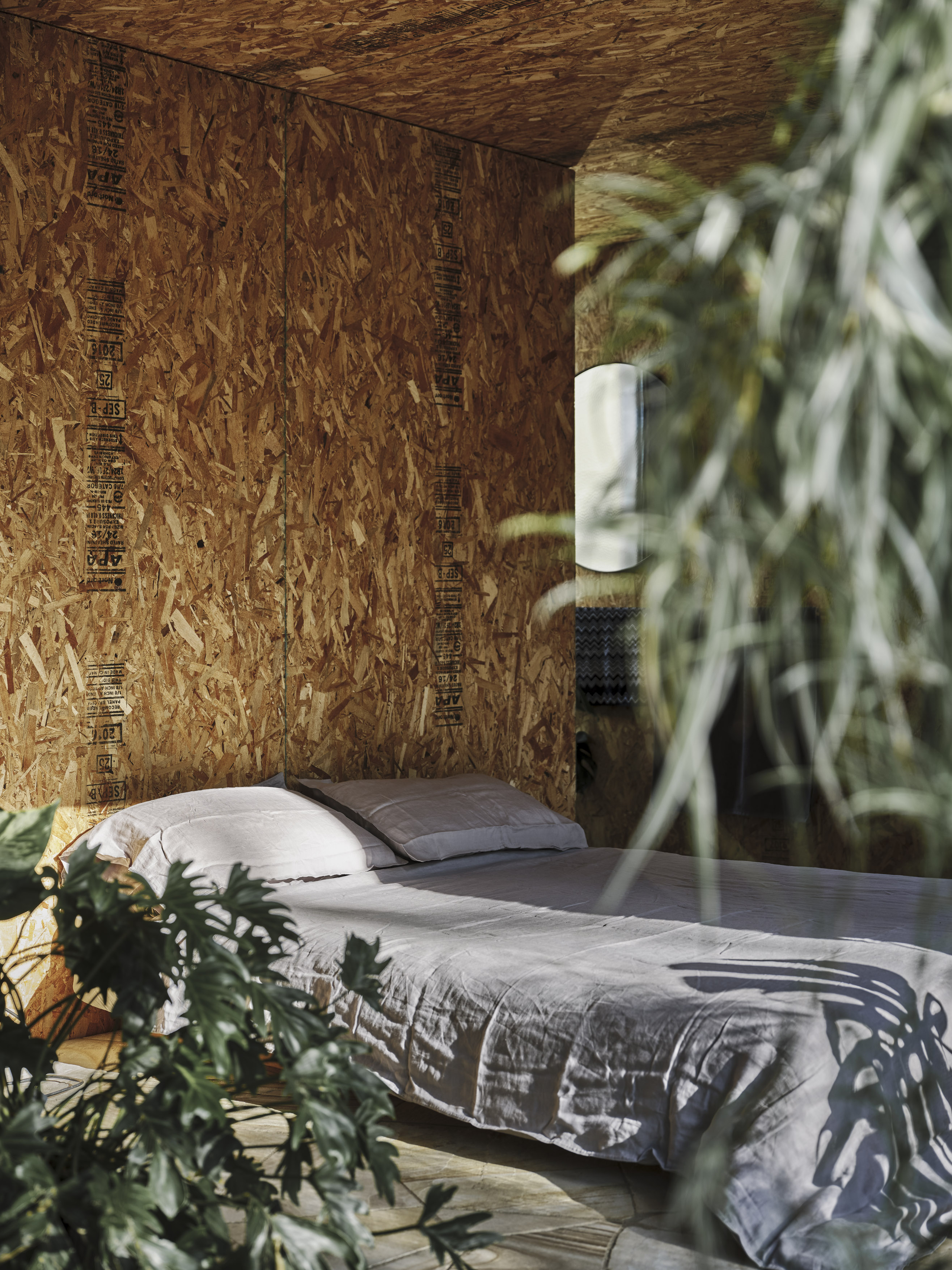 cabin bedroom with exposed raw timber