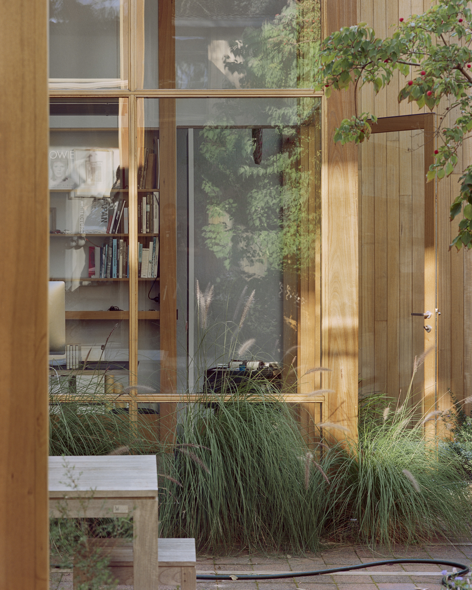 mid century architectural home with high ceilings and full height glazing connecting to garden