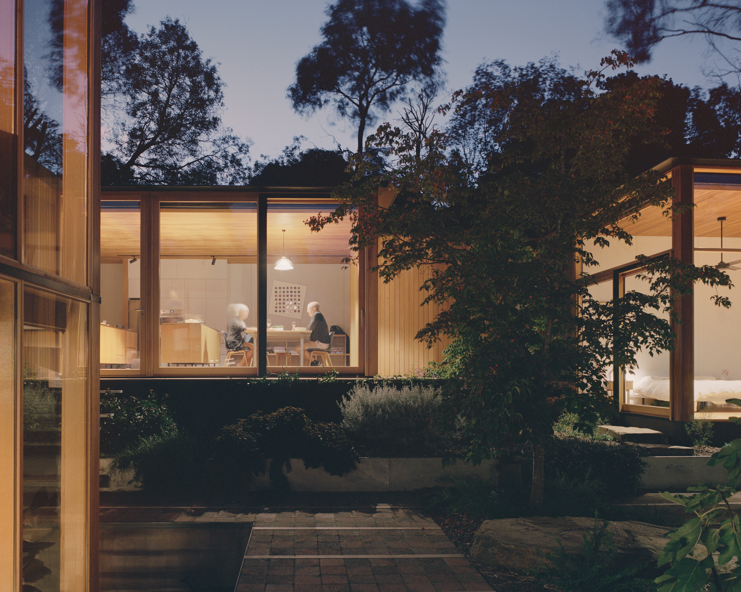 mid century architectural home with high ceilings and full height glazing connecting to garden