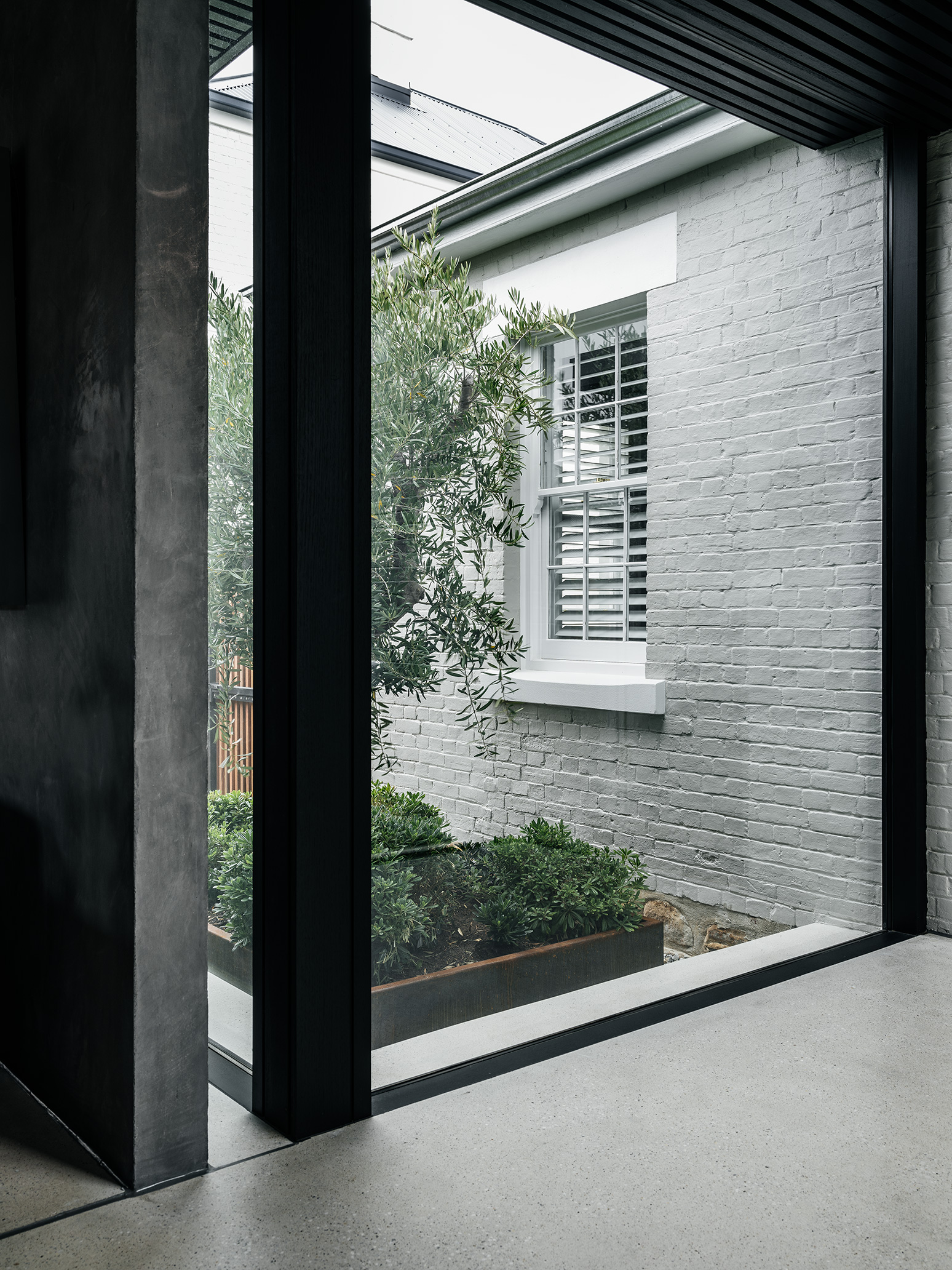internal courtyard space visible through full height glass