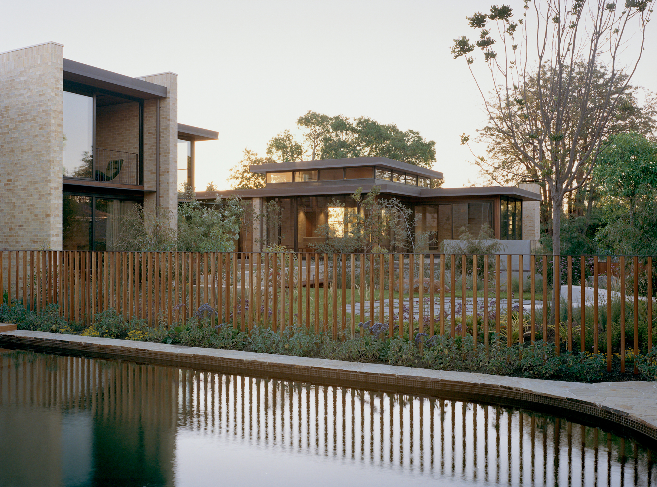 mid century house with pool surrounded by garden