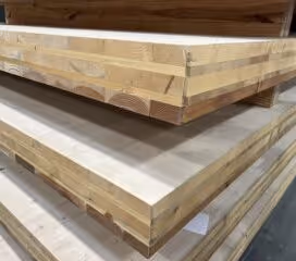 Stacked cross-laminated timber (CLT) panels in a warehouse