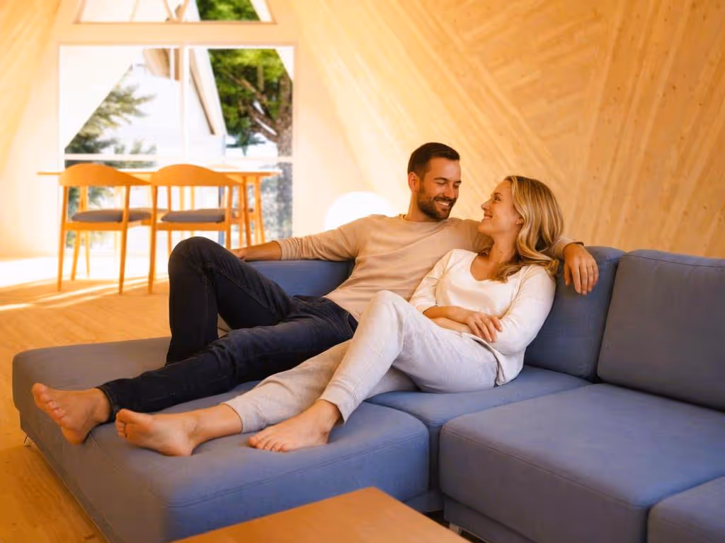 Couple relaxing on a couch inside the Tetra's wood-paneled interior