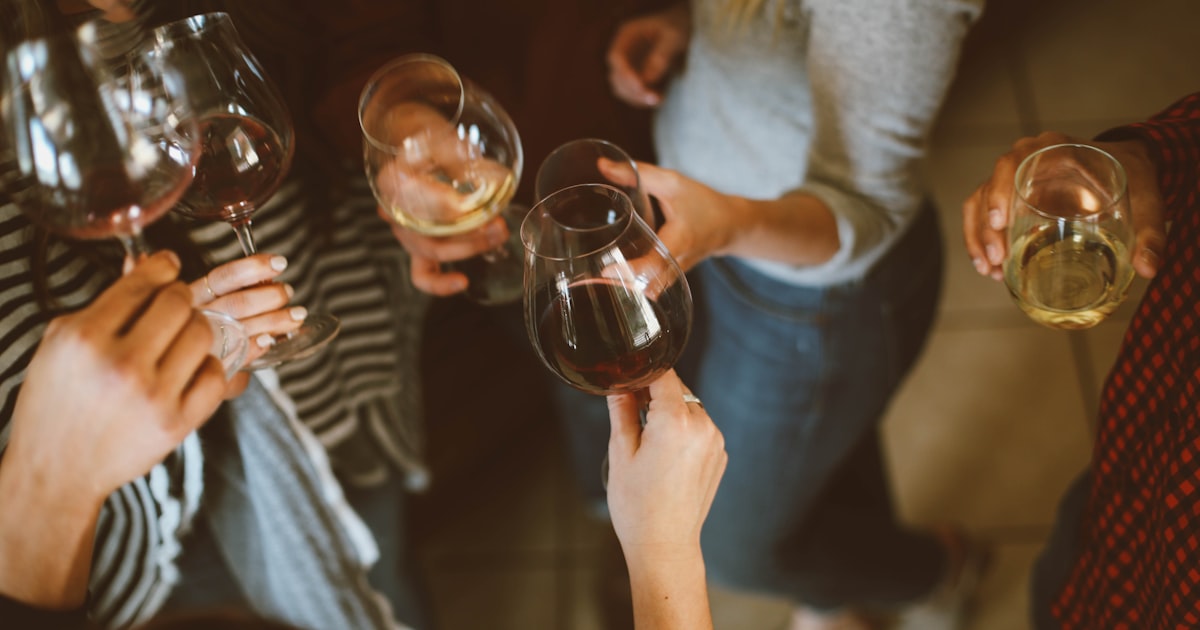 Group of friends cheersing wine glasses at an indoor celebration