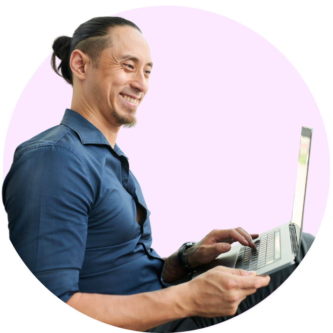 Smiling man looking at laptop
